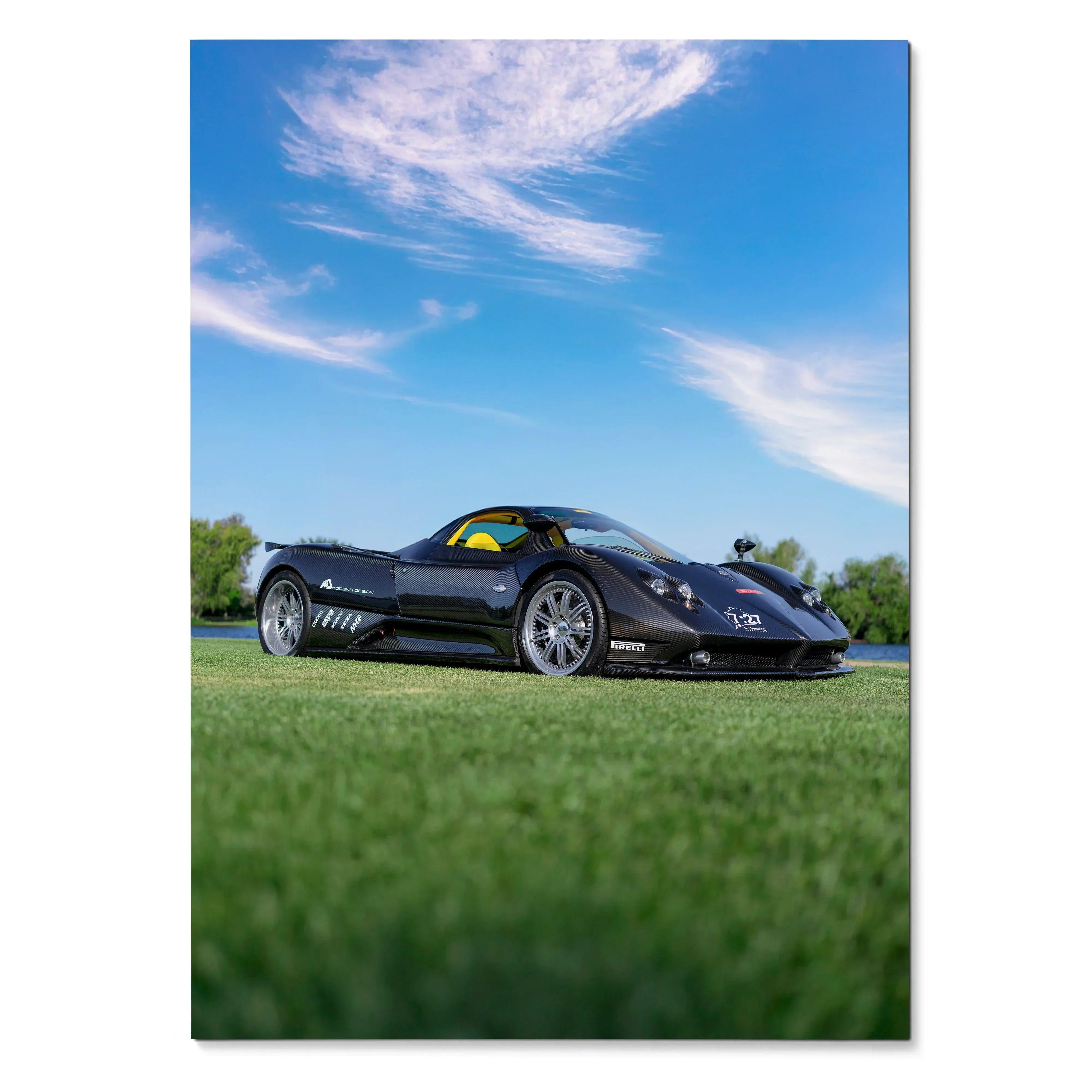 Black Pagani Zonda F Clubsport sports car on grass under bright blue sky poster wall art.