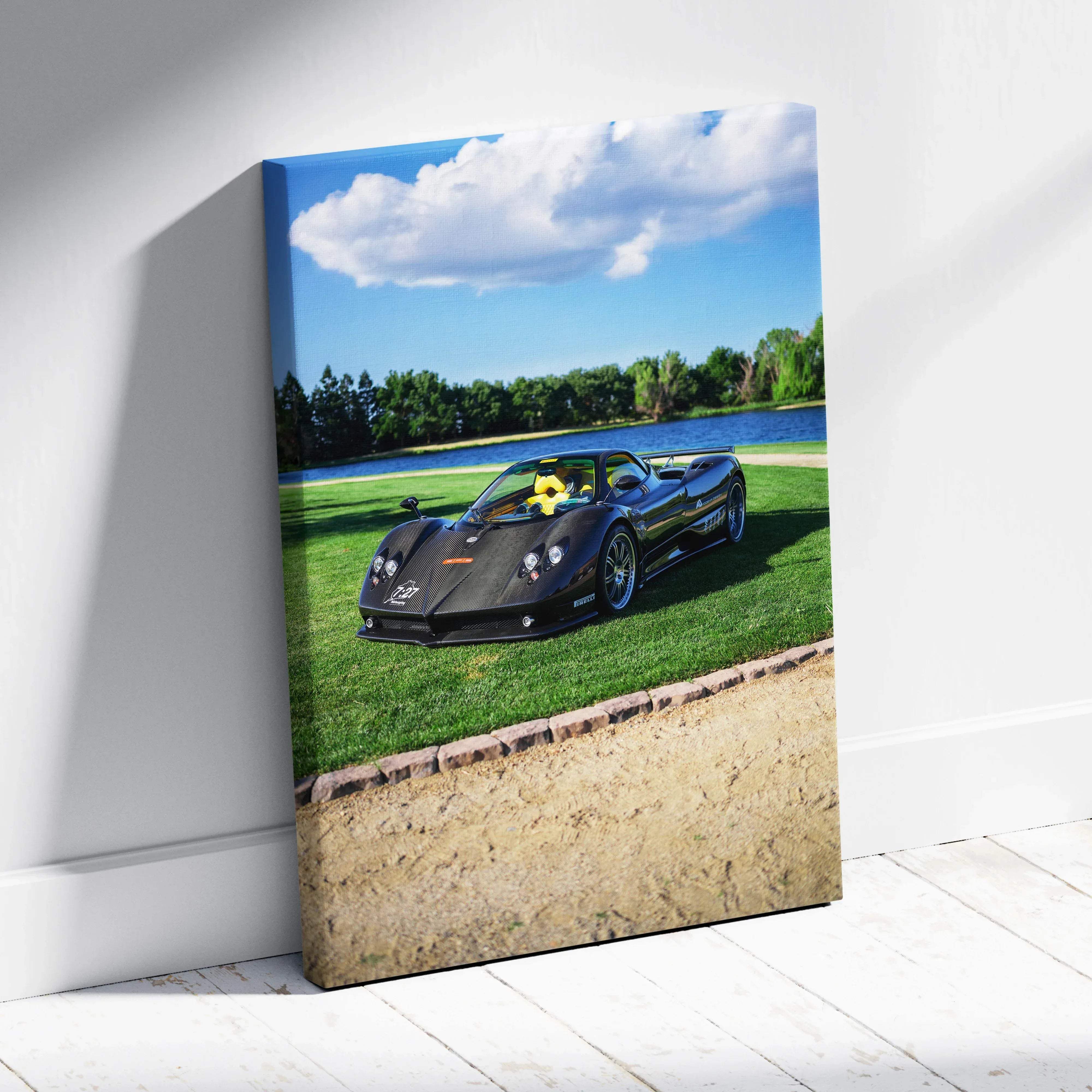 Canvas wall art of black carbon fiber pagani zonda f clubsport with yellow interior on lush green grass by lake