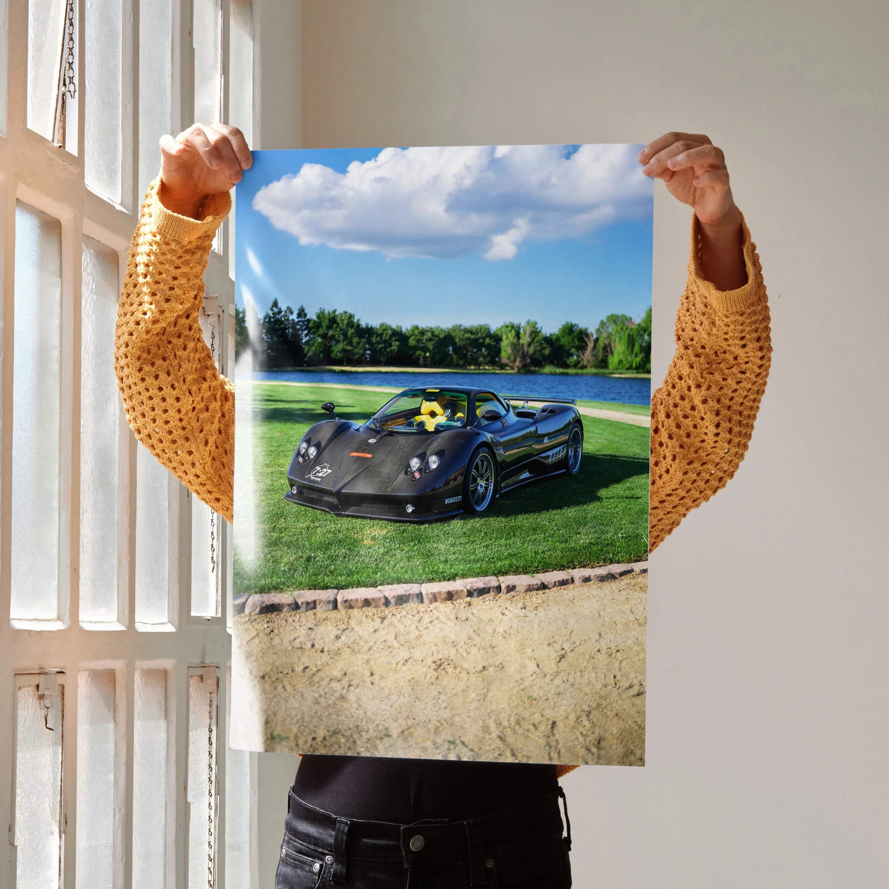 Pagani Zonda F Clubsport car poster showing sleek black sports car on green grass under blue sky wall art.