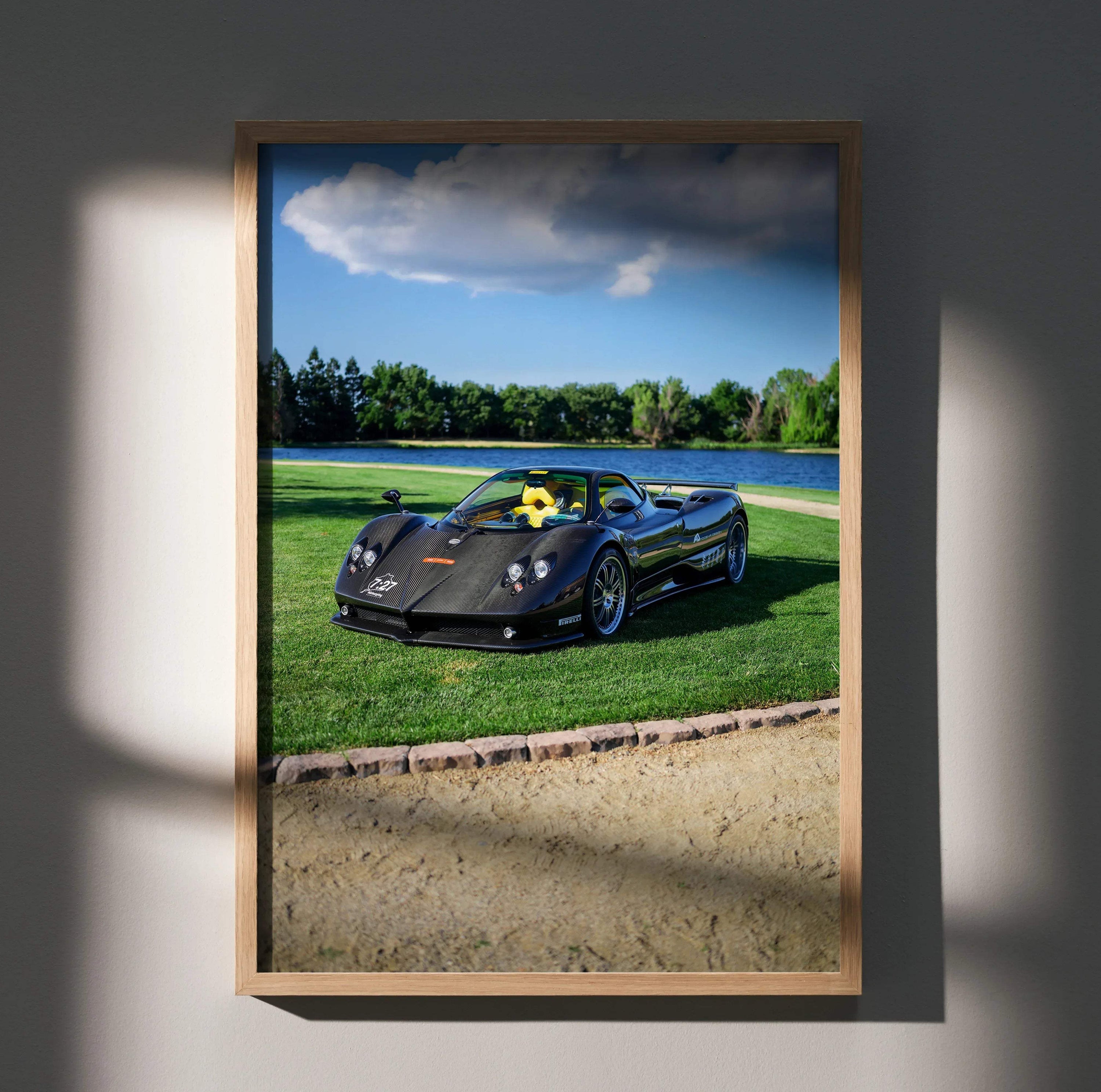 Pagani Zonda F Clubsport black sports car poster with green grass and blue sky wall art.