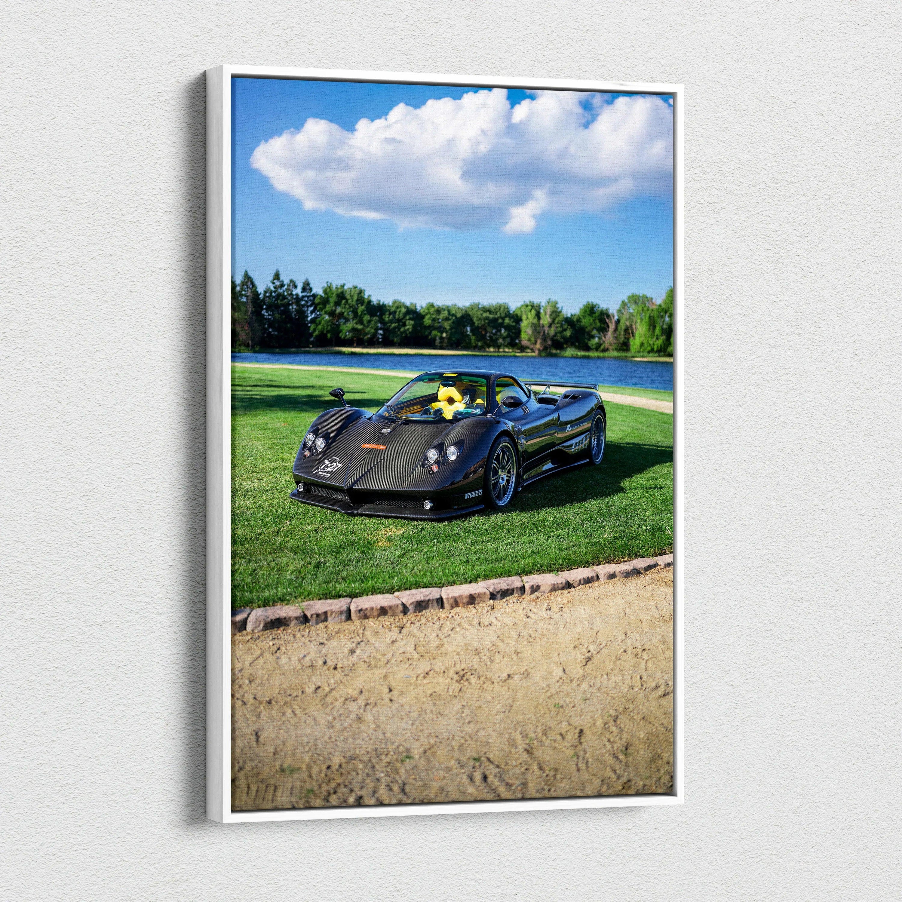 Vertical canvas art featuring a black Pagani Zonda F Clubsport sports car on green grass under blue sky with clouds.