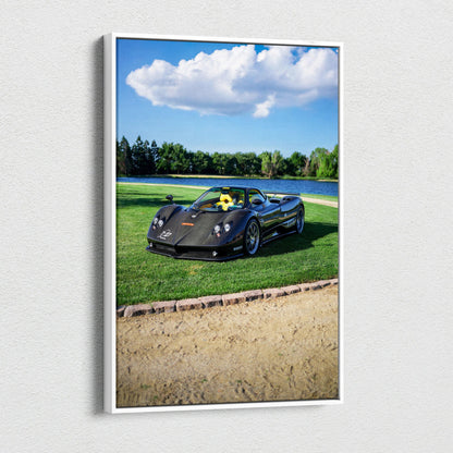 Vertical canvas art featuring a black Pagani Zonda F Clubsport sports car on green grass under blue sky with clouds.