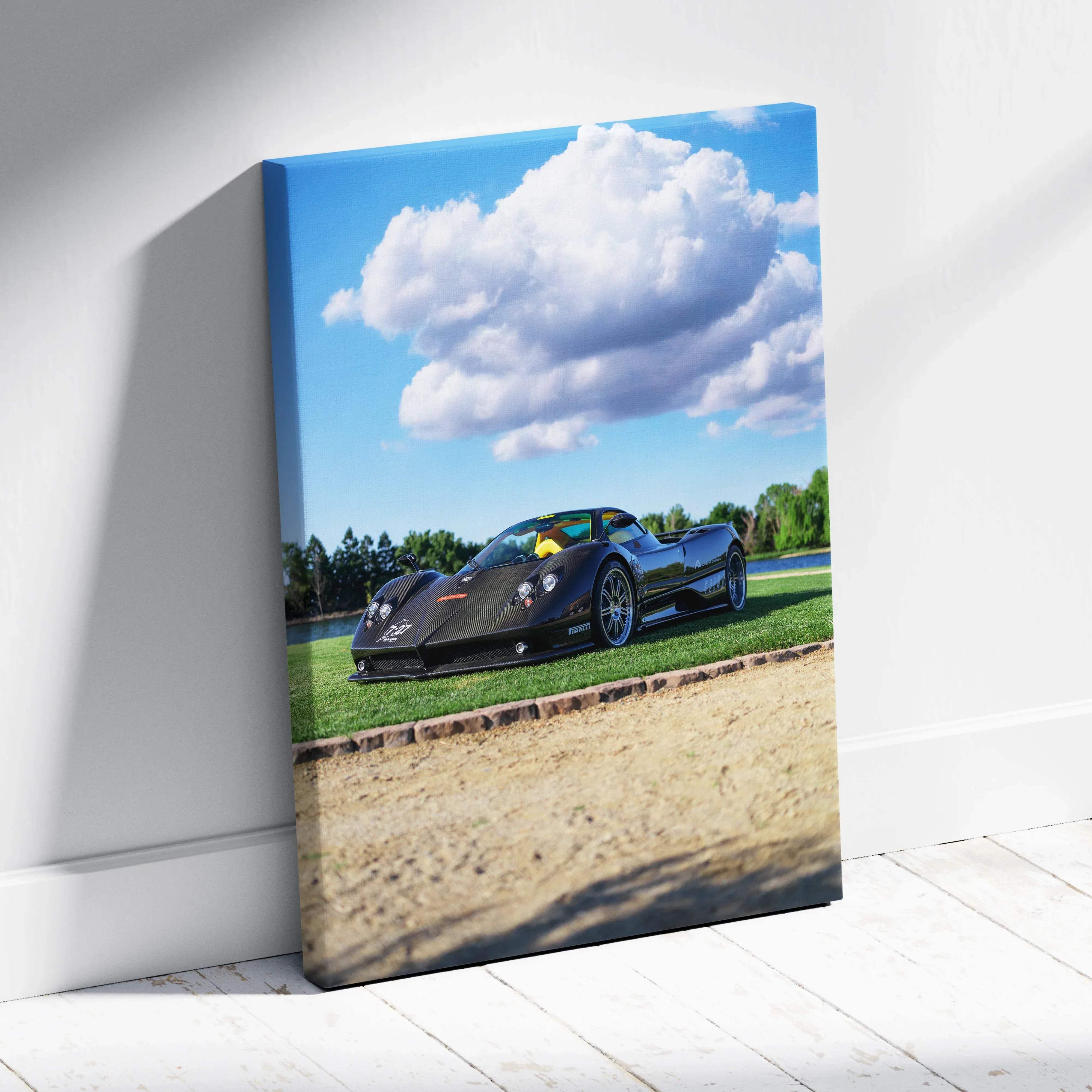 Canvas wall art featuring premium automotive photography of a sleek black pagani zonda f clubsport on grass with sky