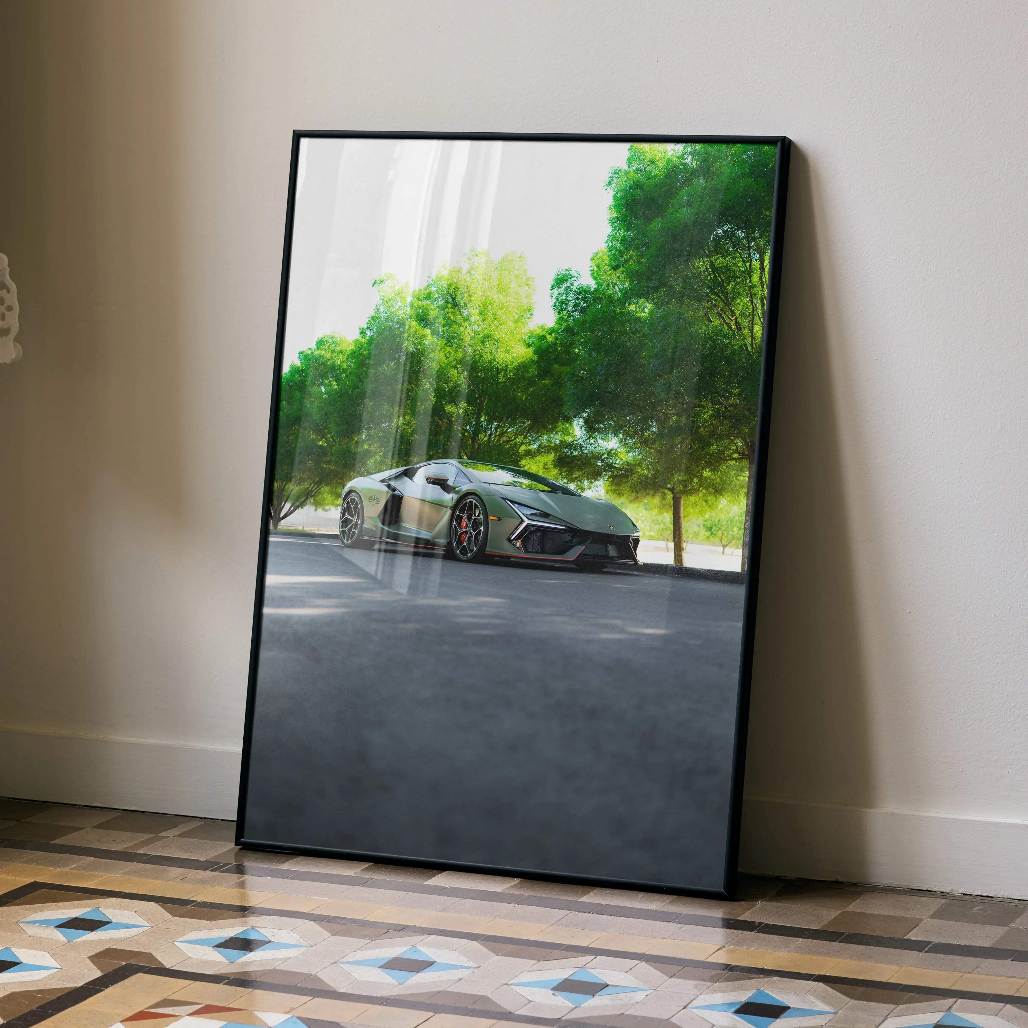 A framed poster of a matte green Lamborghini Revuelto sports car parked under lush trees in high resolution