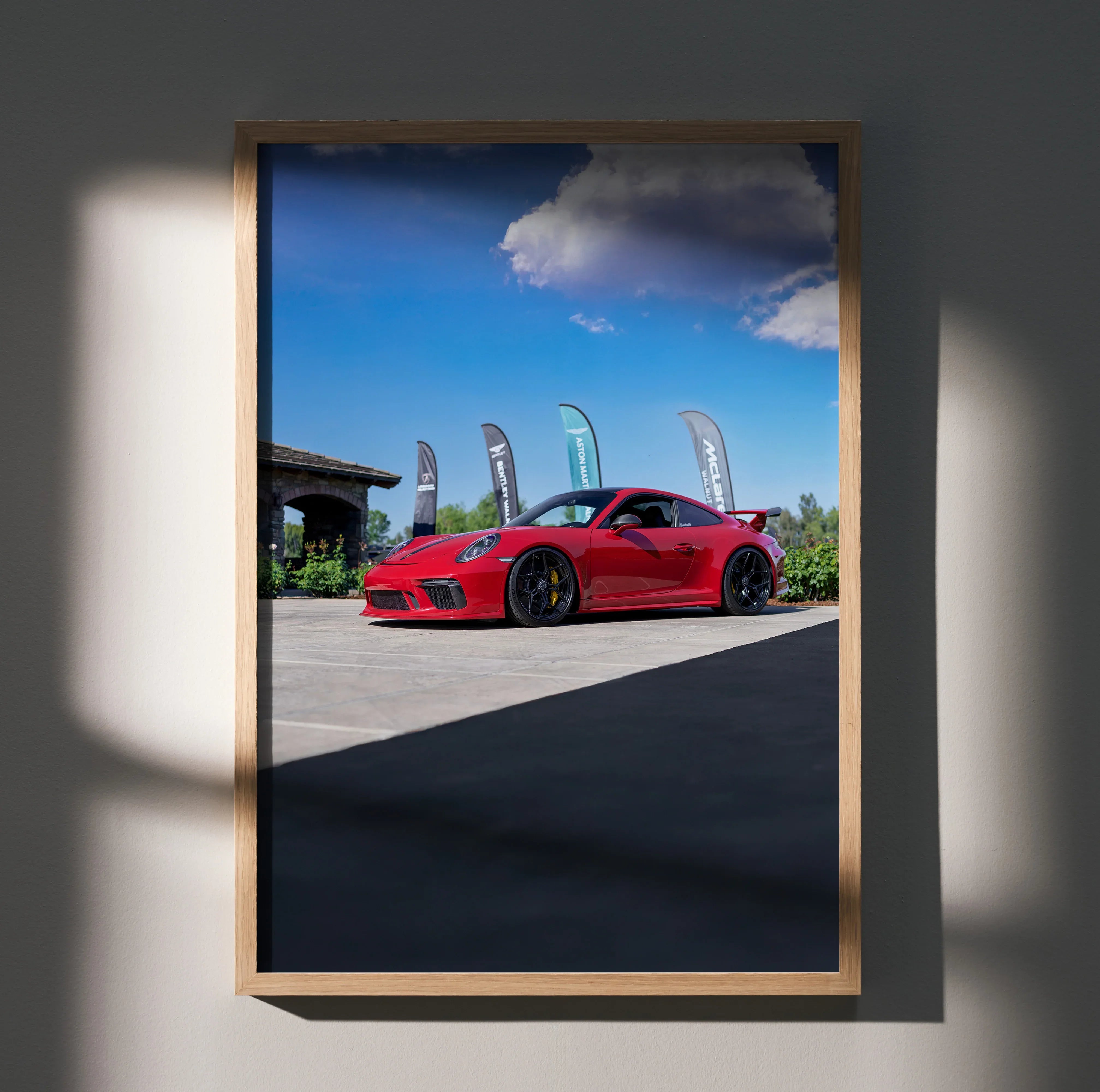 Porsche 911 GT3 red sports car poster with clear blue sky wall art in wooden frame.
