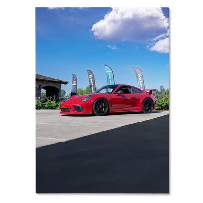 Red Porsche 911 GT3 parked outdoors under blue sky, glossy sports car poster wall art.