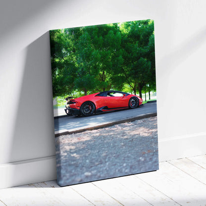 Red Lamborghini Huracan convertible parked under green trees on vertical canvas wall art.