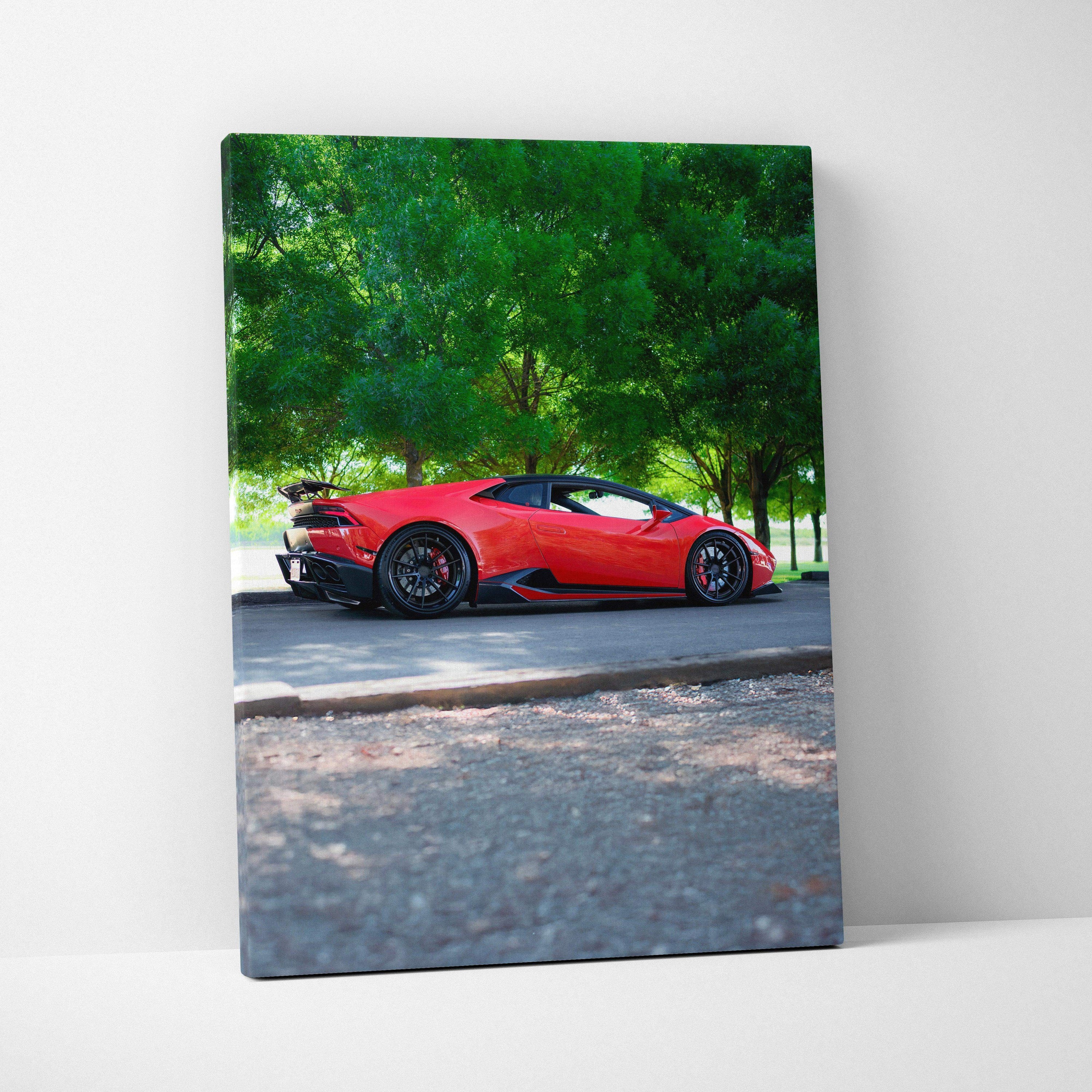 Vertical canvas art featuring a red Lamborghini Huracan parked under green trees, automotive wall art.
