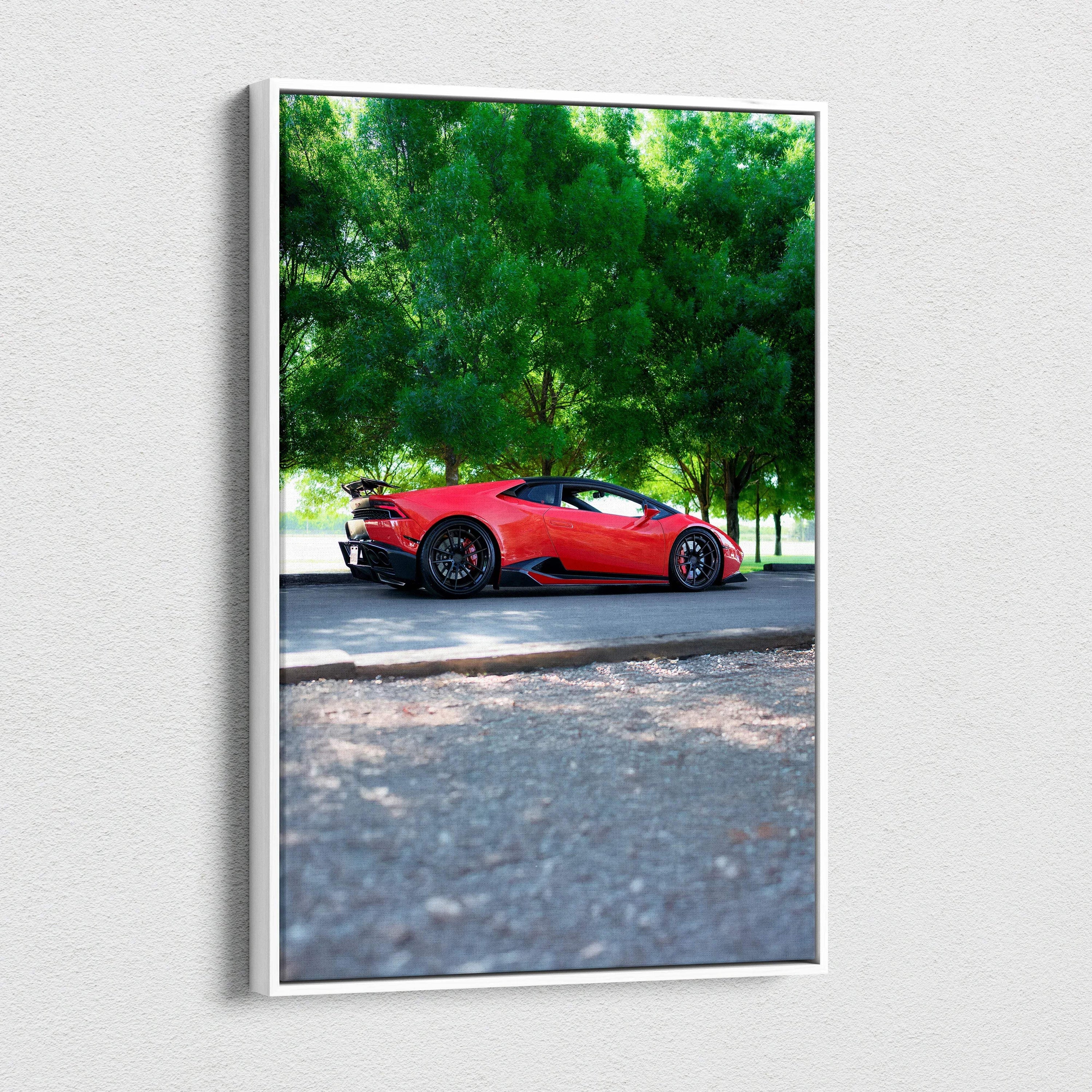 Vertical canvas art of red Lamborghini Huracan parked on road with green trees background.