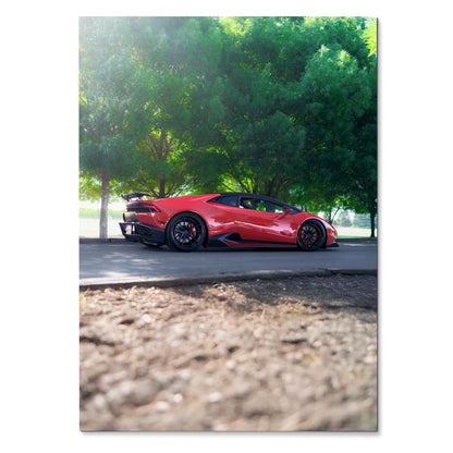 Red Lamborghini Huracan parked under green trees, high-resolution poster wall art.