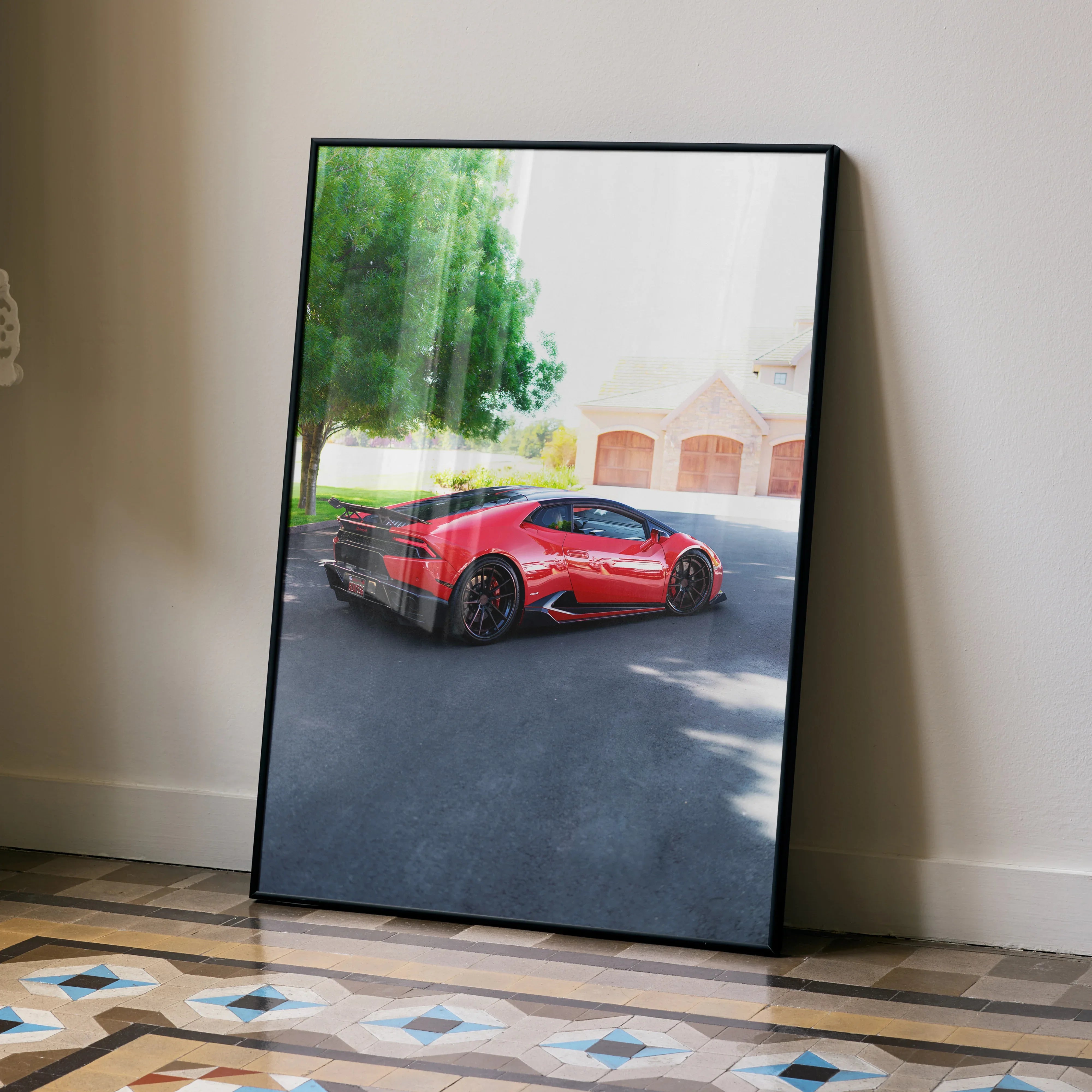 Lamborghini Huracan poster wall art with red sports car and residential background in black frame.