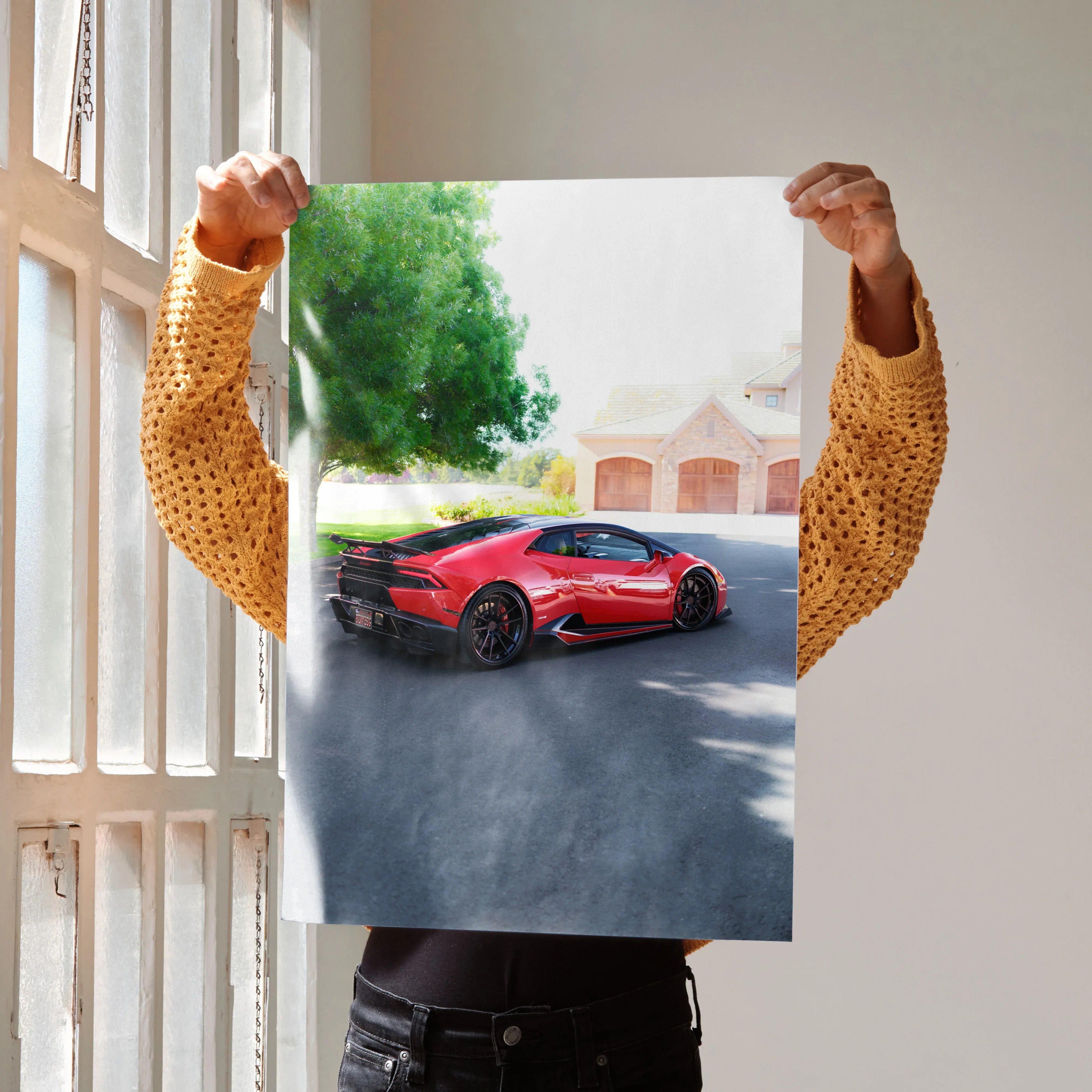 Red Lamborghini Huracan parked near modern homes poster wall art in natural light.