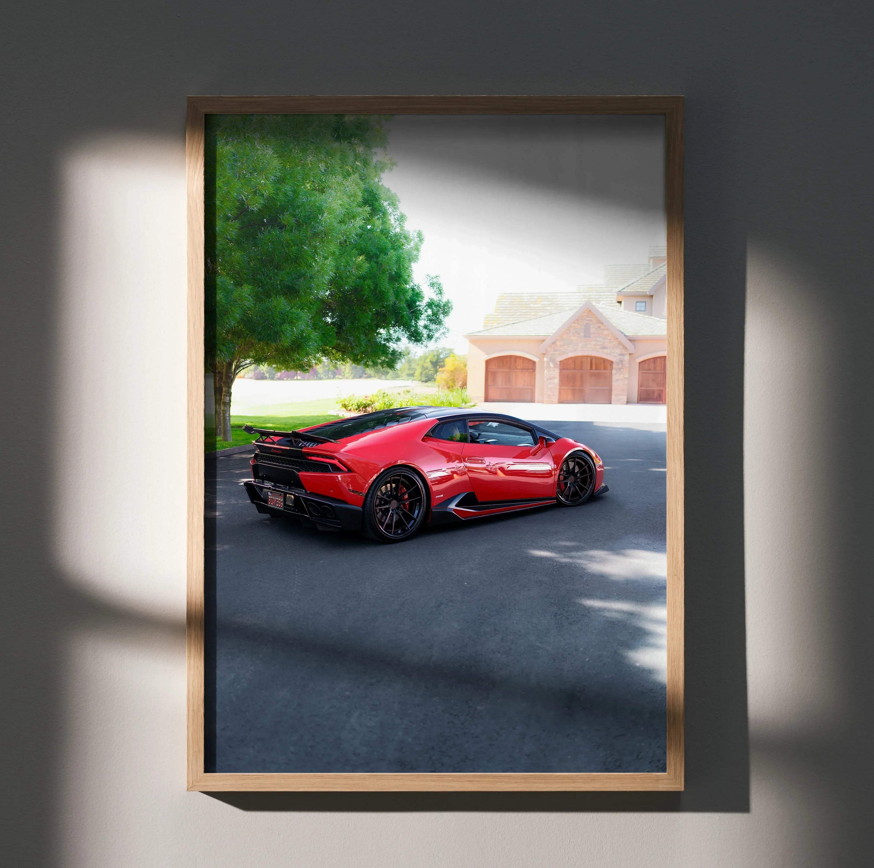 Red Lamborghini Huracan parked in driveway, framed poster wall art with house and tree background.
