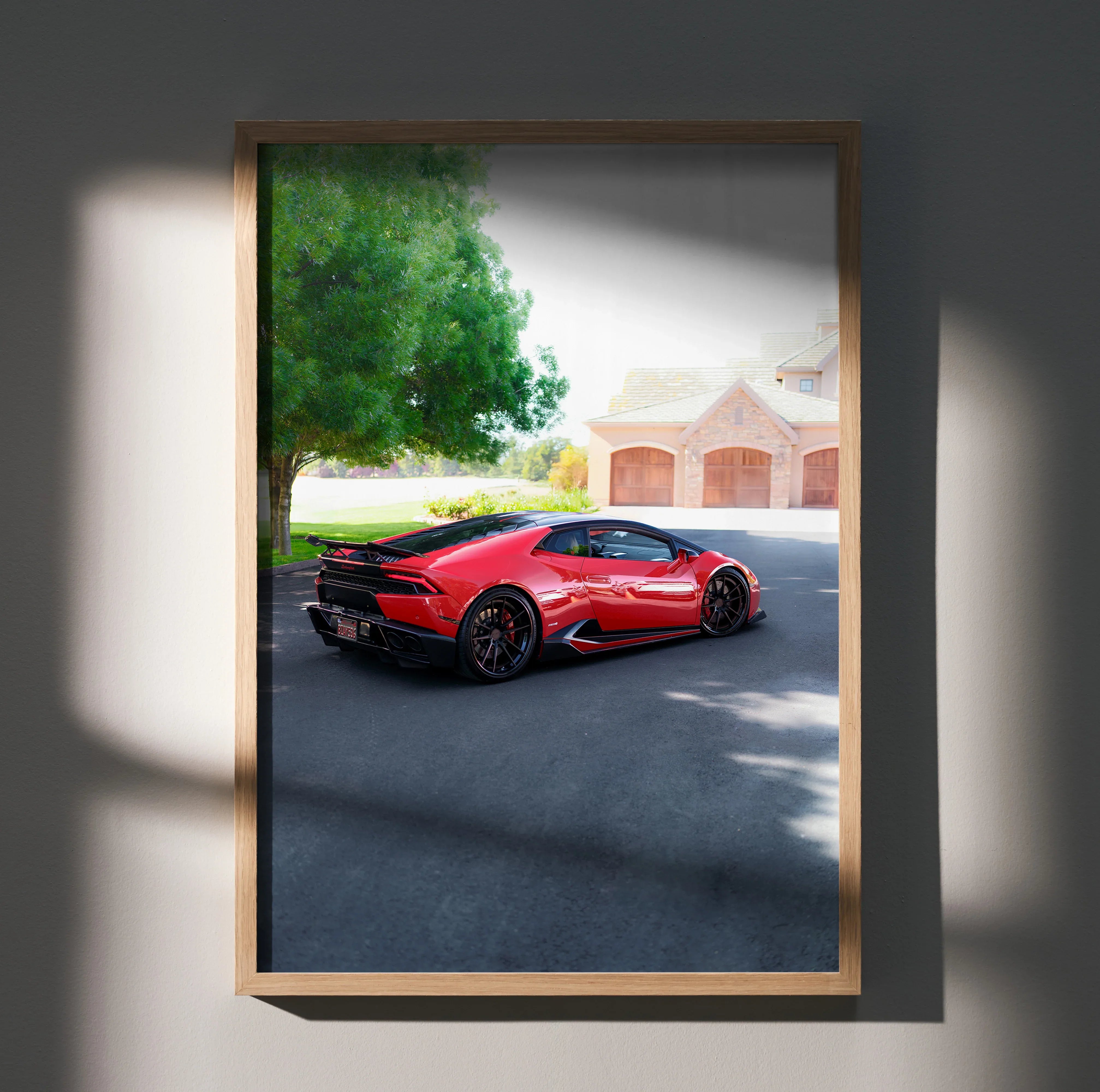 Red Lamborghini Huracan parked in driveway, framed poster wall art with house and tree background.