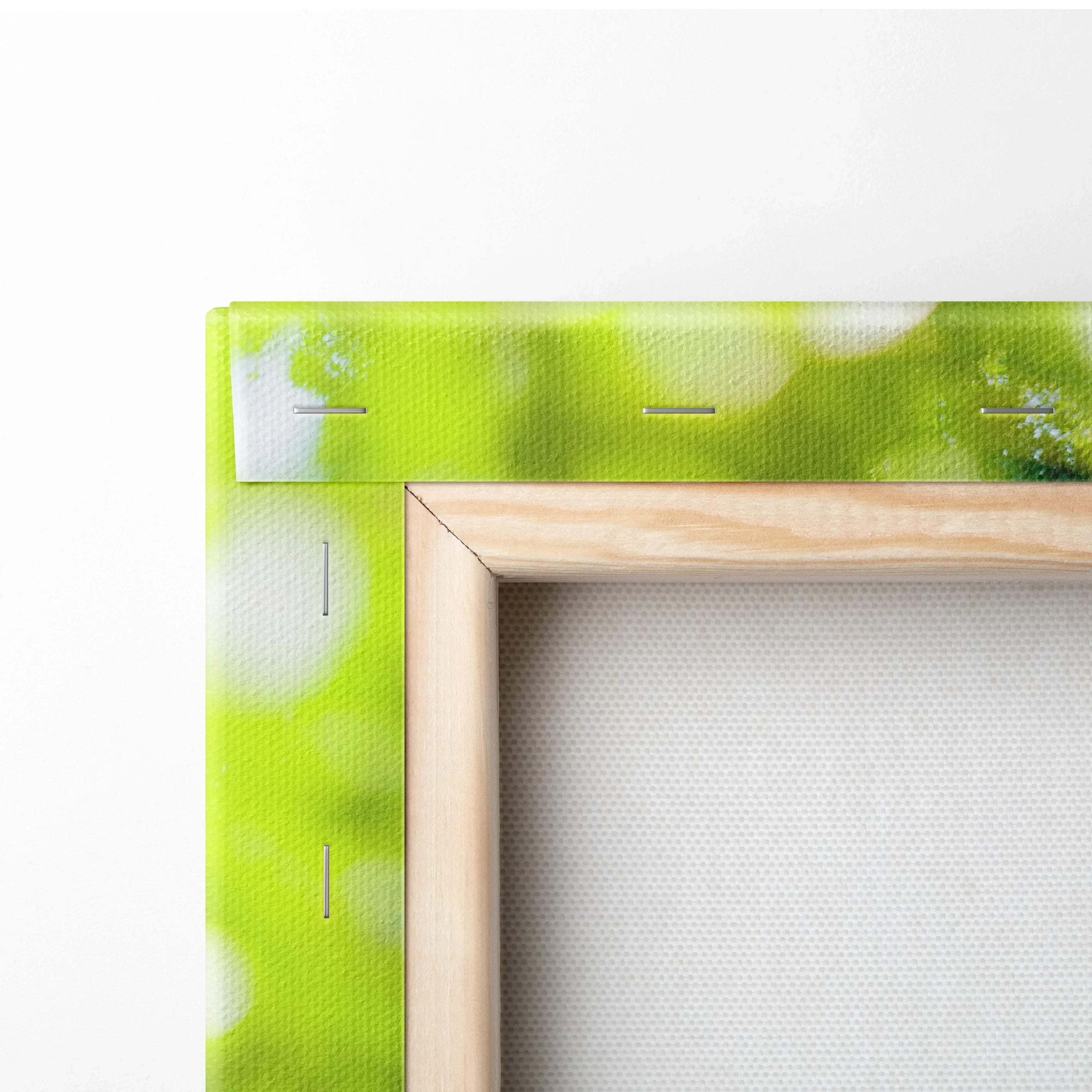 Close-up of wooden framed canvas wall art with vibrant green and white abstract design.