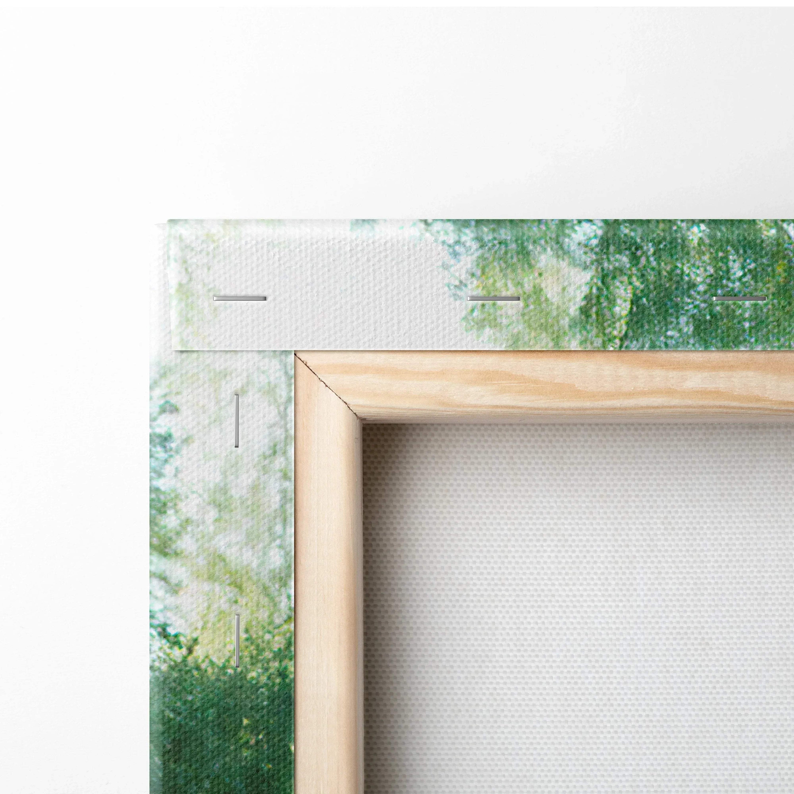 Close-up of wooden frame and stretched canvas corner with subtle forest print detail on vertical canvas art wall decor.