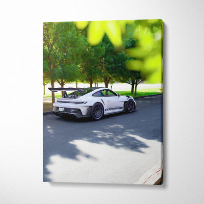 Vertical canvas art of white Porsche 911 GT3 RS parked on street with trees and shadows.