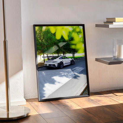 Porsche 911 GT3 RS driving on a sunny road framed as stylish poster wall art.