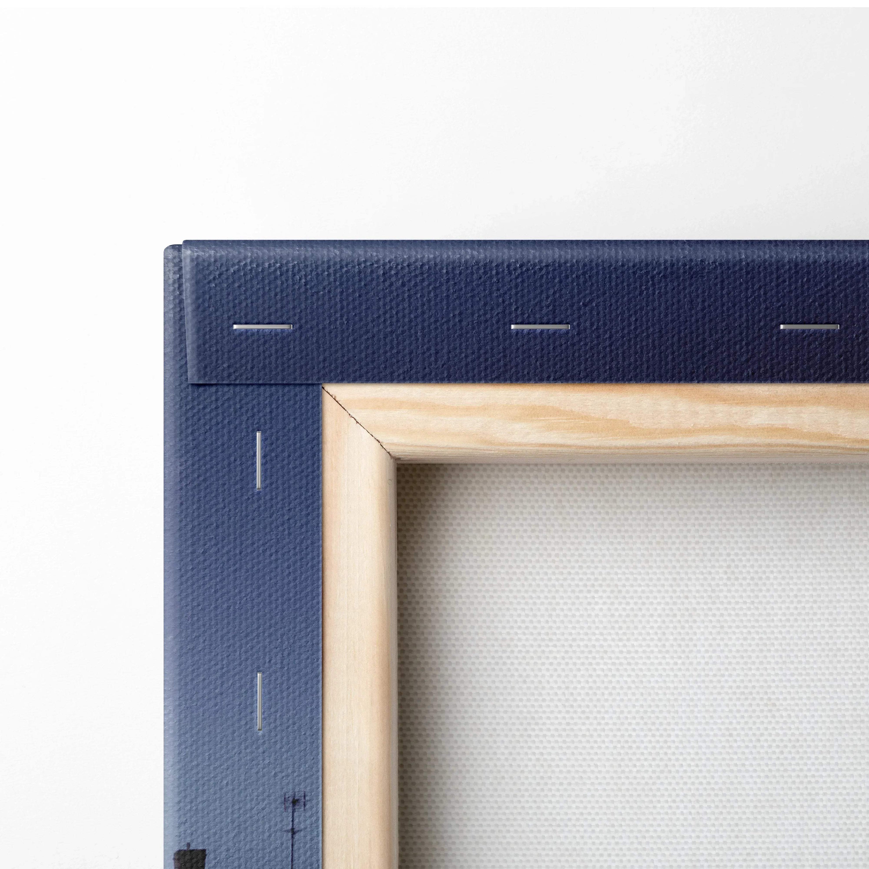 Close-up of corner detail on navy blue stretched canvas wall art with wooden frame edges.