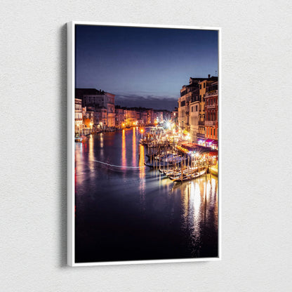 Canvas wall art featuring a digitally enhanced nighttime urban landscape with illuminated buildings reflecting on water.
