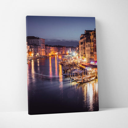 Canvas wall art featuring a nighttime urban canal scene with illuminated buildings and reflections on water.