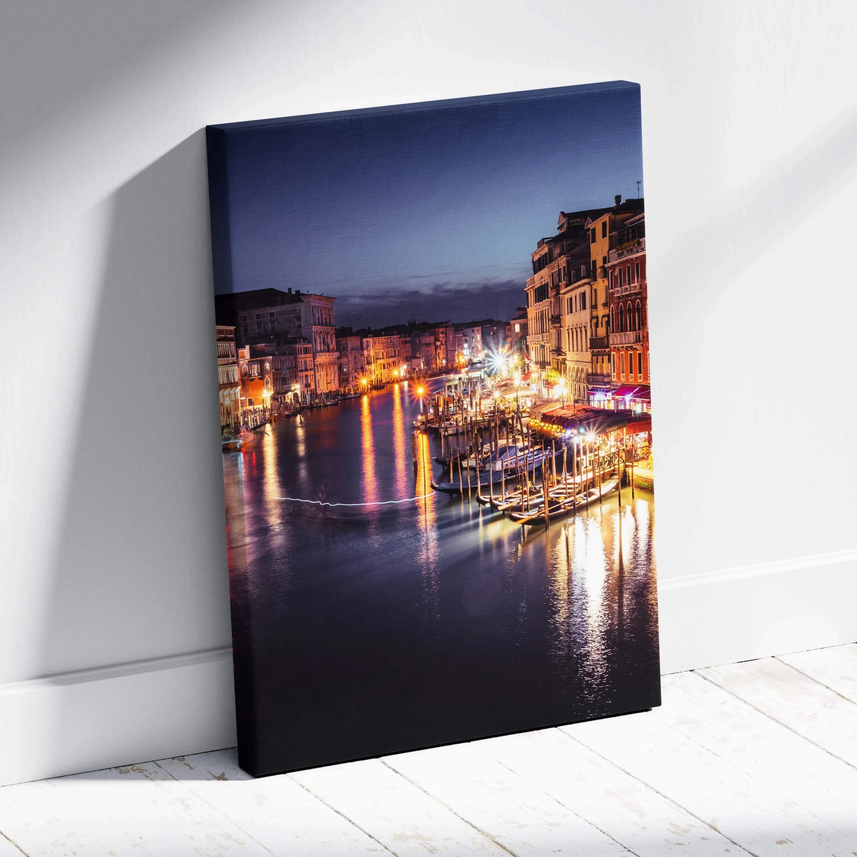 Canvas wall art featuring a nighttime urban canal with illuminated buildings and reflections on water.
