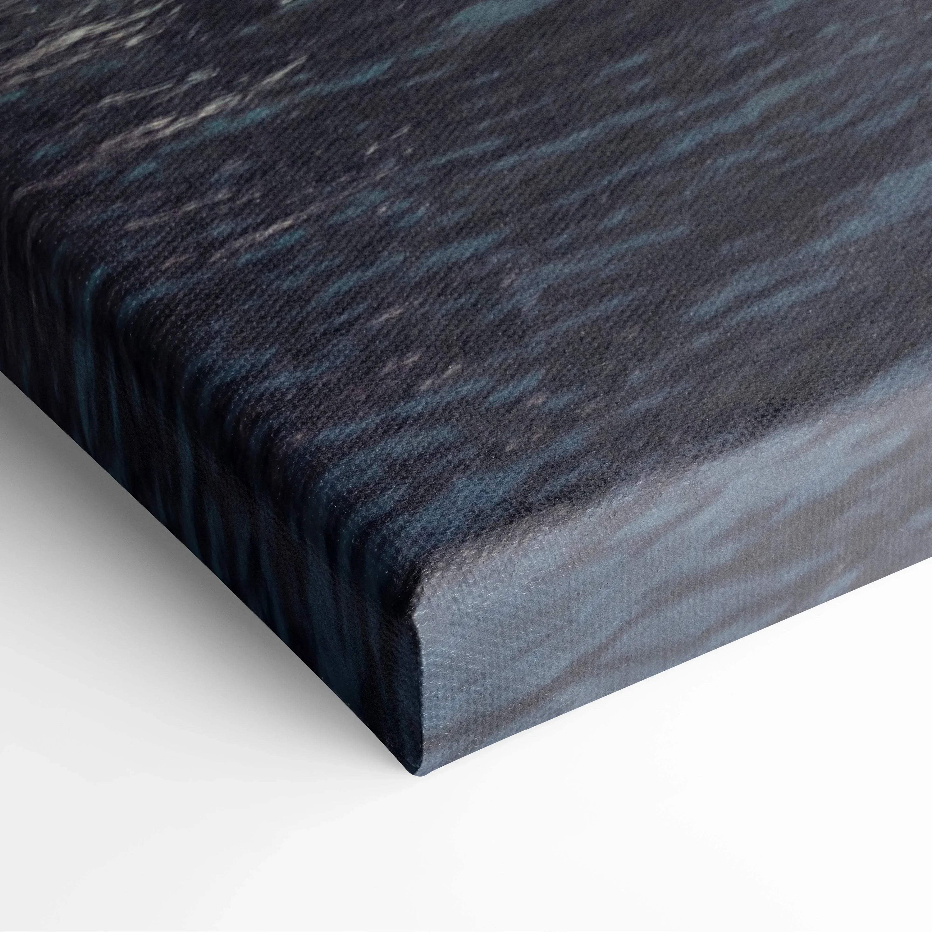 Close-up of wrapped canvas art with dark blue and black abstract architectural digital design on textured fabric surface.