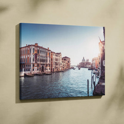 Canvas wall art depicting a serene Venetian canal with historic buildings under a clear blue sky.