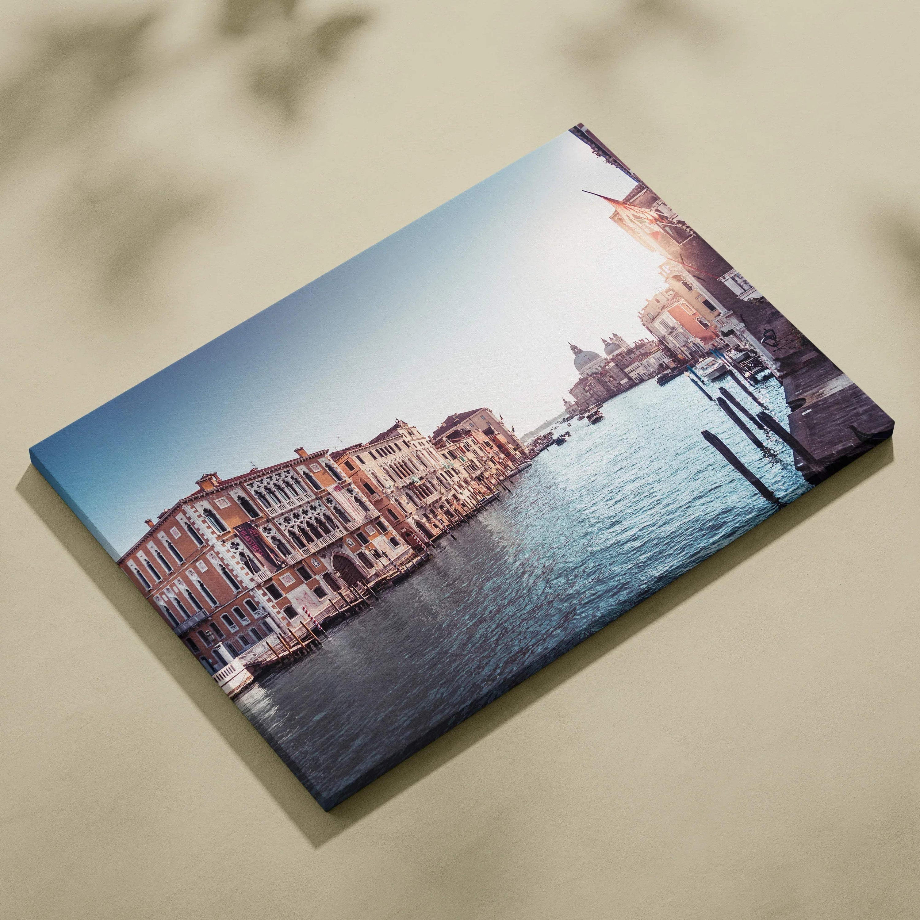 Canvas wall art featuring stunning architecture of riverside buildings at sunset with soft blue sky and water reflections.
