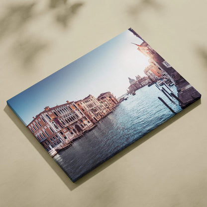Canvas wall art featuring stunning architecture of riverside buildings at sunset with soft blue sky and water reflections.