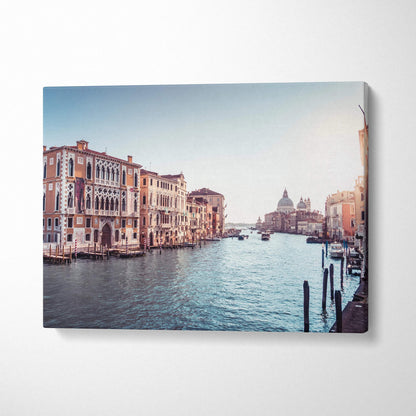 Horizontal canvas wall art featuring a serene canal scene with classic Venetian buildings and soft blue sky.