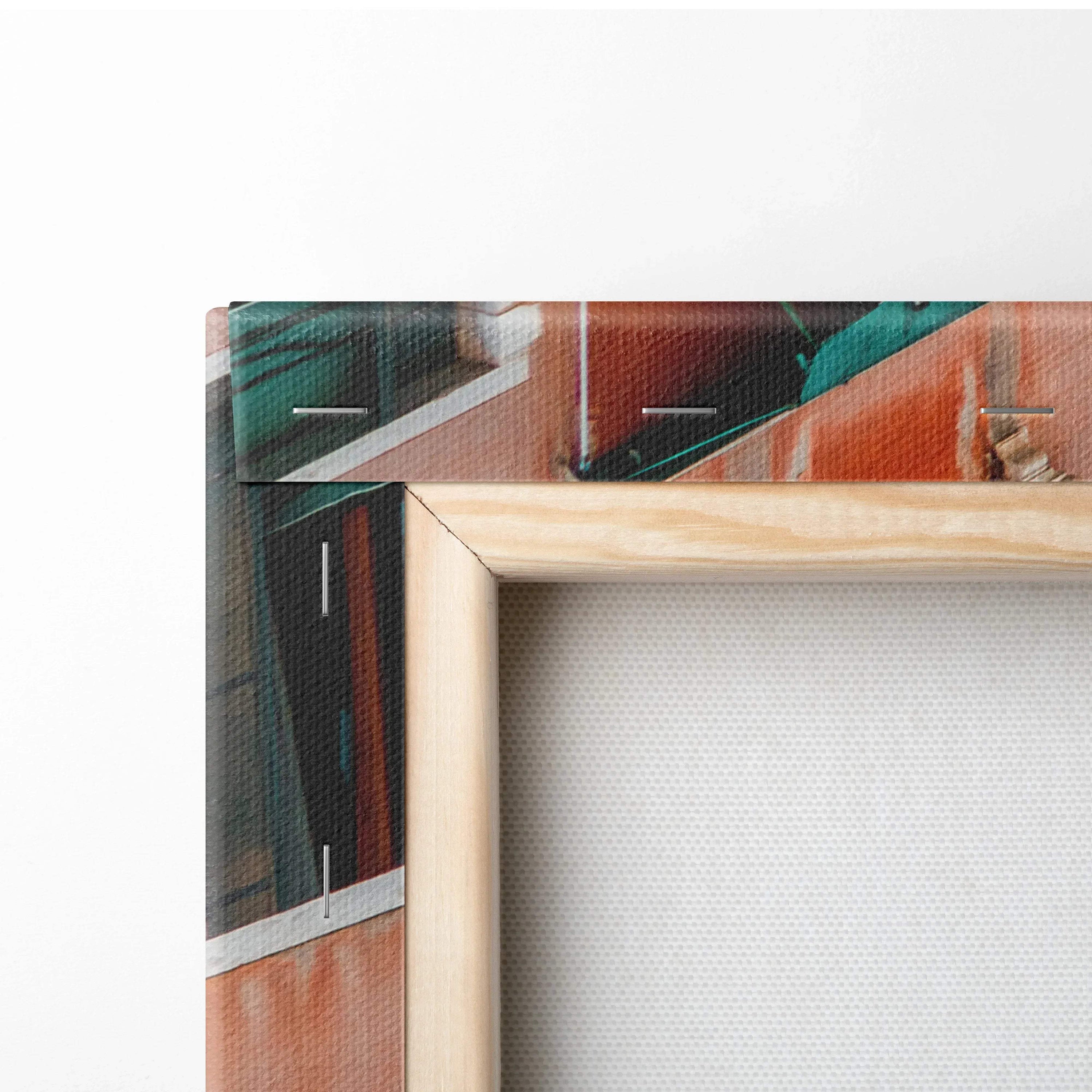 Close-up of corner of canvas wall art with natural wooden frame and vibrant architectural digital print.