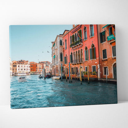 Canvas wall art featuring vibrant, detailed architecture of colorful buildings along a canal with boats and a bright blue.