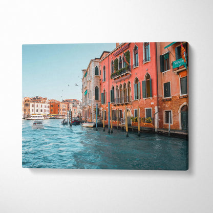 Canvas wall art featuring colorful Venetian buildings along a canal with boats and clear blue sky.