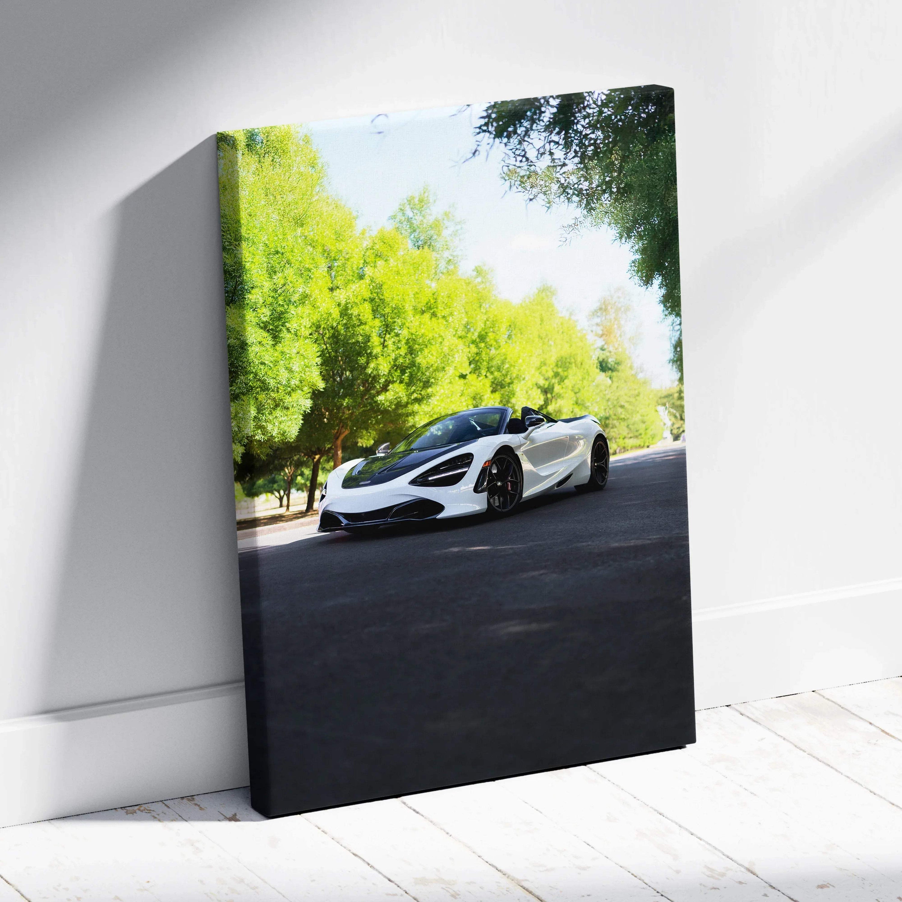 Vertical canvas art featuring a white McLaren 720S on a tree-lined road with bright green foliage.