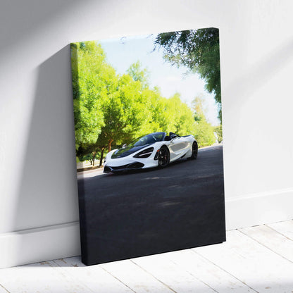Vertical canvas art featuring a white McLaren 720S on a tree-lined road with bright green foliage.