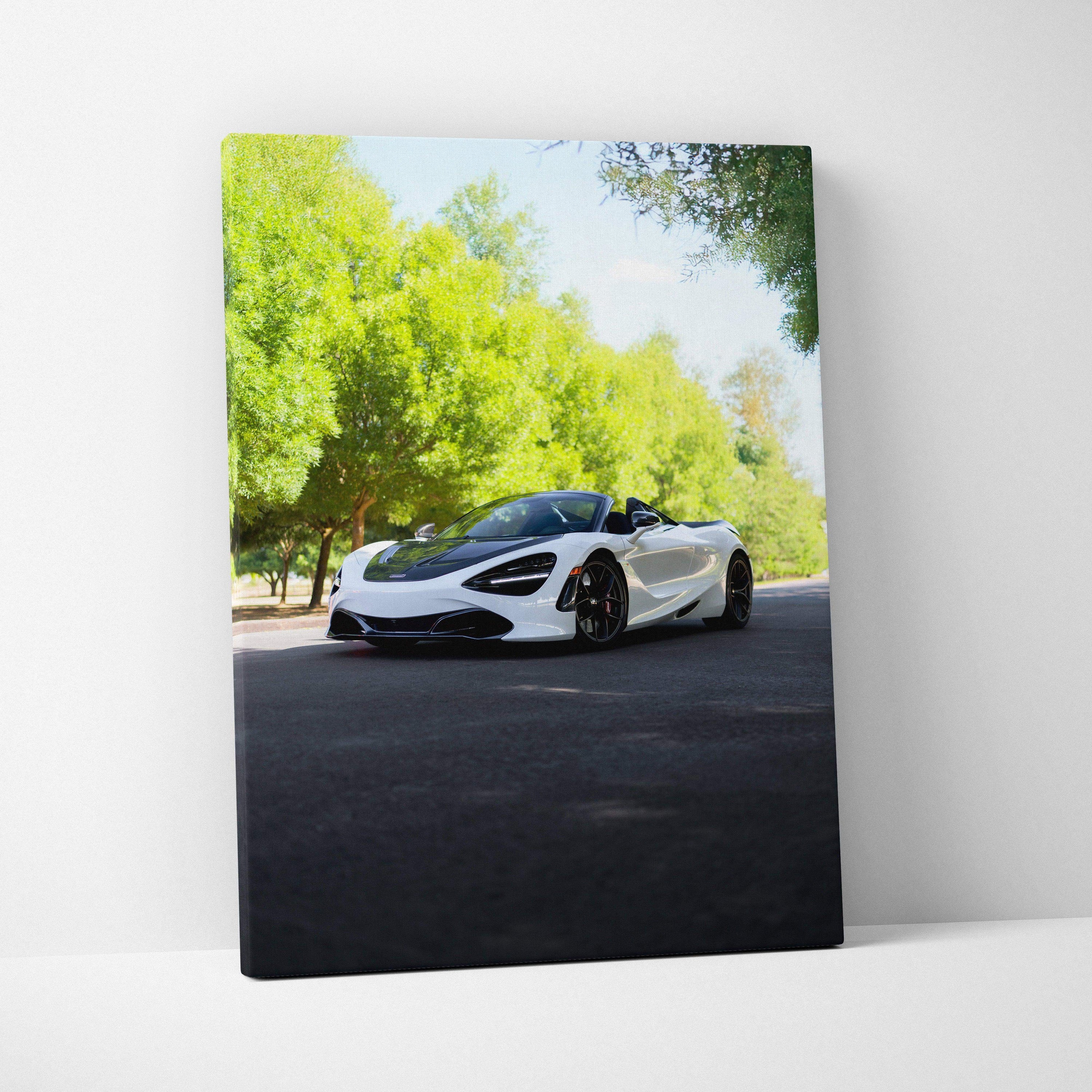White McLaren 720S on black road with green trees vertical canvas wall art.