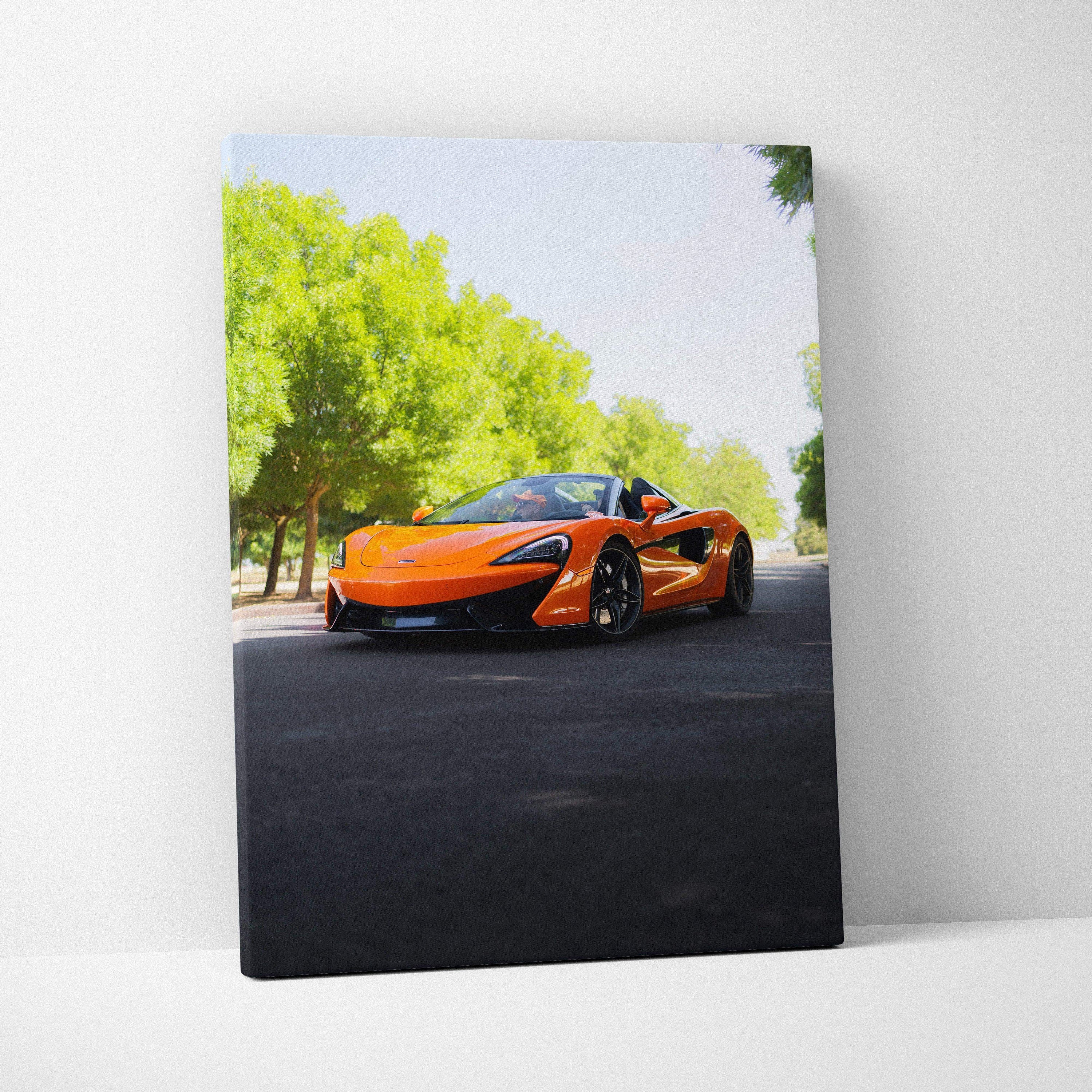 Vertical canvas art depicting an orange McLaren 570S on a tree-lined road, high-resolution wall art.