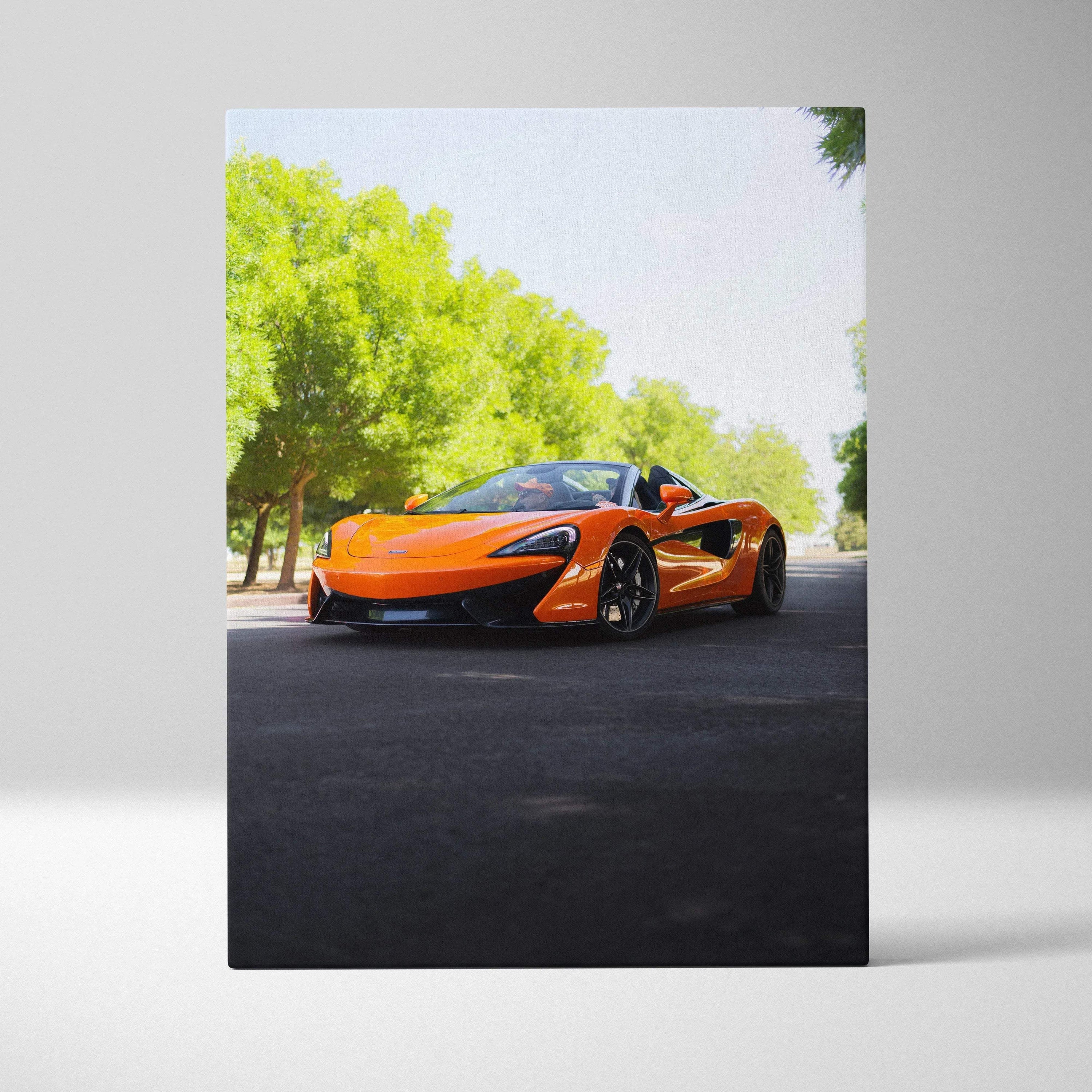 Orange McLaren 570S sports car on road with green trees in high-resolution vertical canvas wall art.
