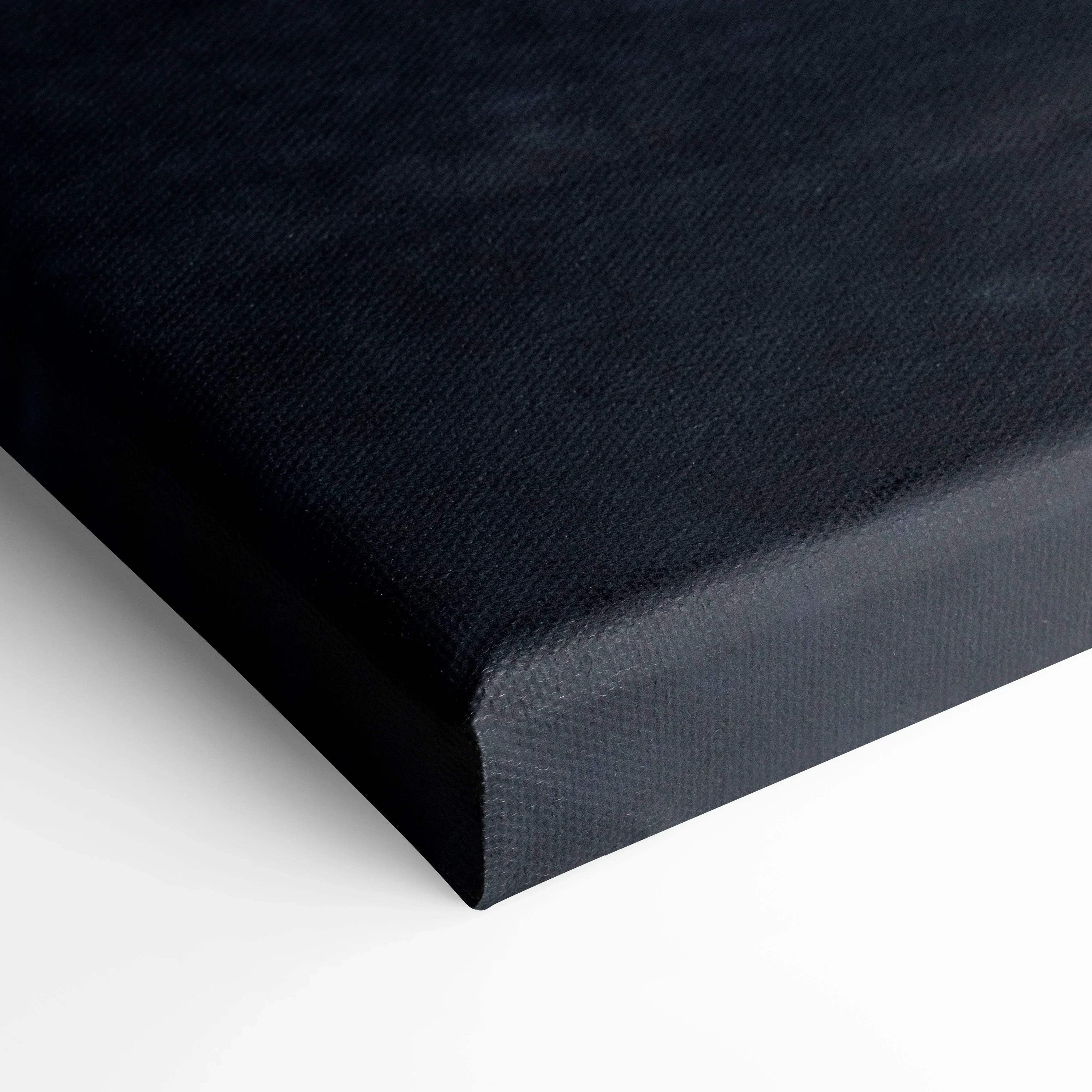 Close-up of black textured canvas corner on vertical wall art print with clean edges and solid color base.