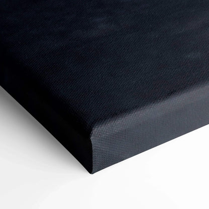 Close-up of black textured canvas corner on vertical wall art print with clean edges and solid color base.