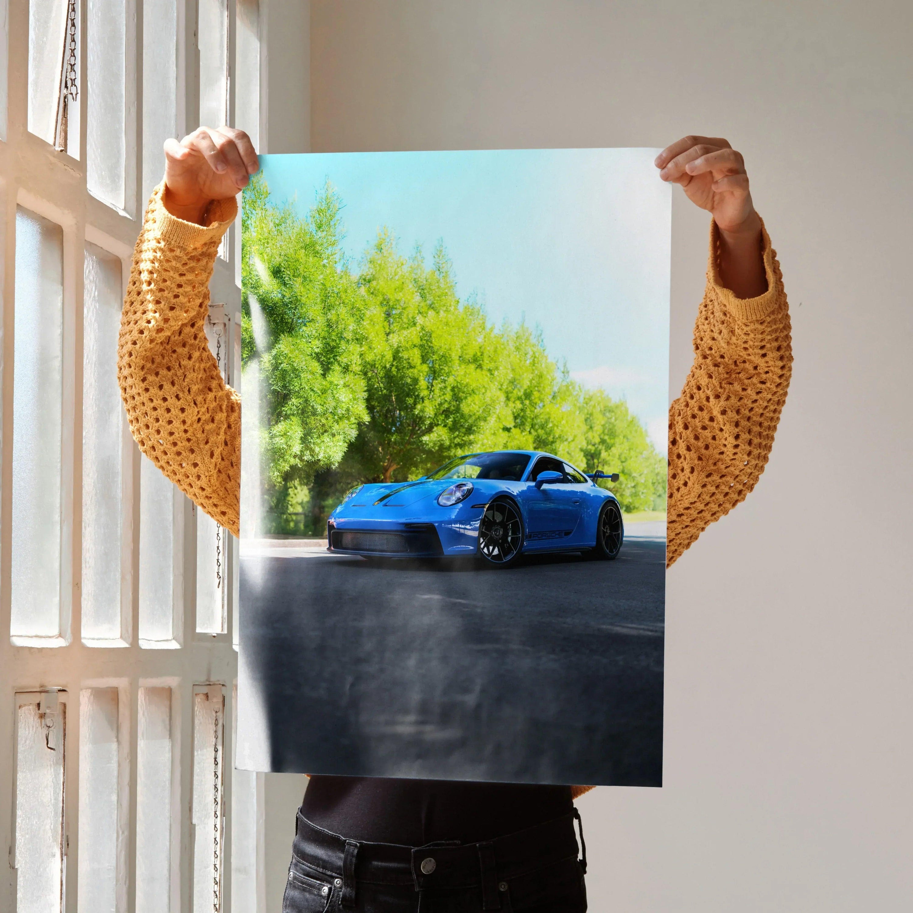 Porsche 911 GT3 in blue on road with green trees background poster wall art.