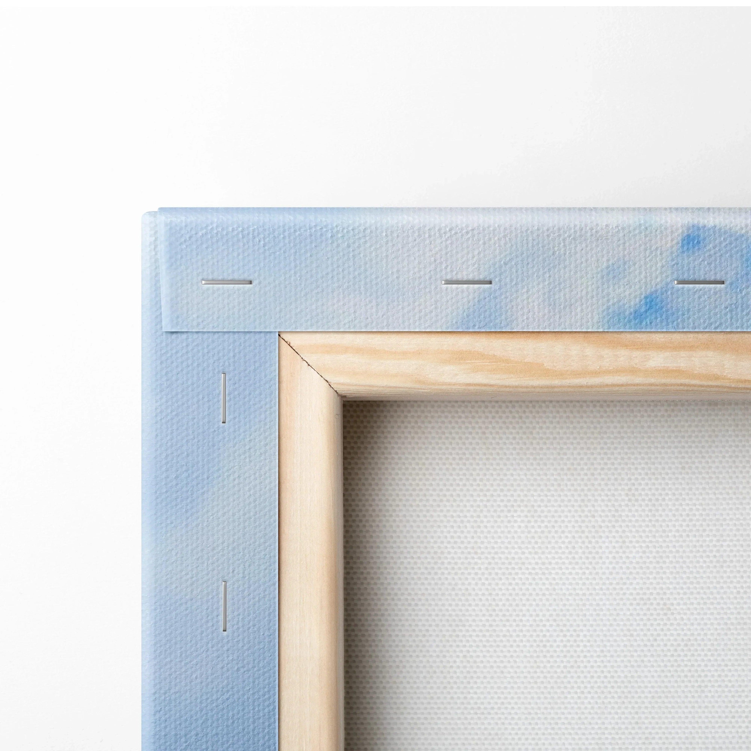 Close-up of wooden frame and corner stitching on blue sky-themed canvas art wall print.
