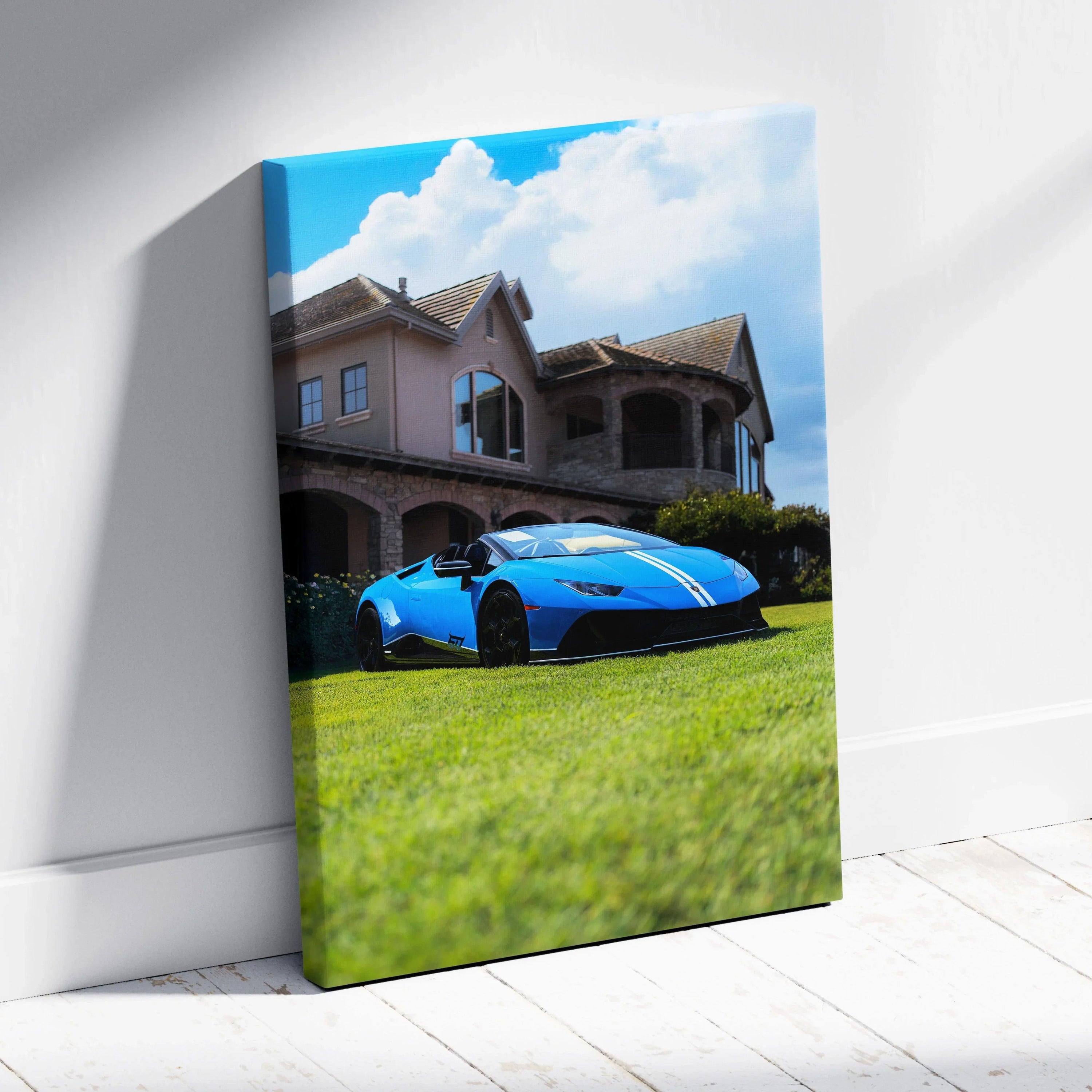 Blue Lamborghini Huracan parked on grass in front of large house canvas wall art.