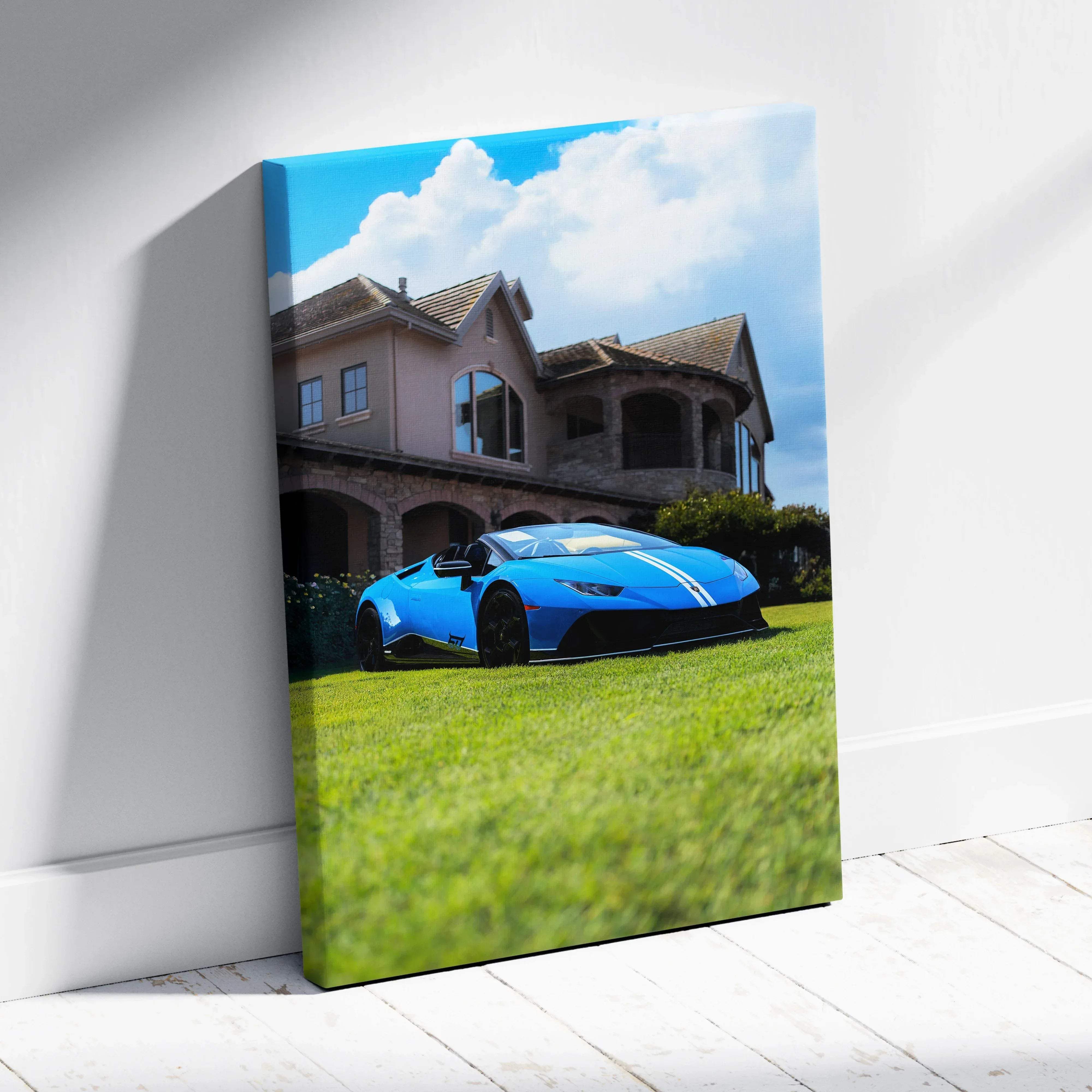 Canvas wall art featuring a vibrant blue Lamborghini Huracan with white racing stripes parked on grass by a luxury house