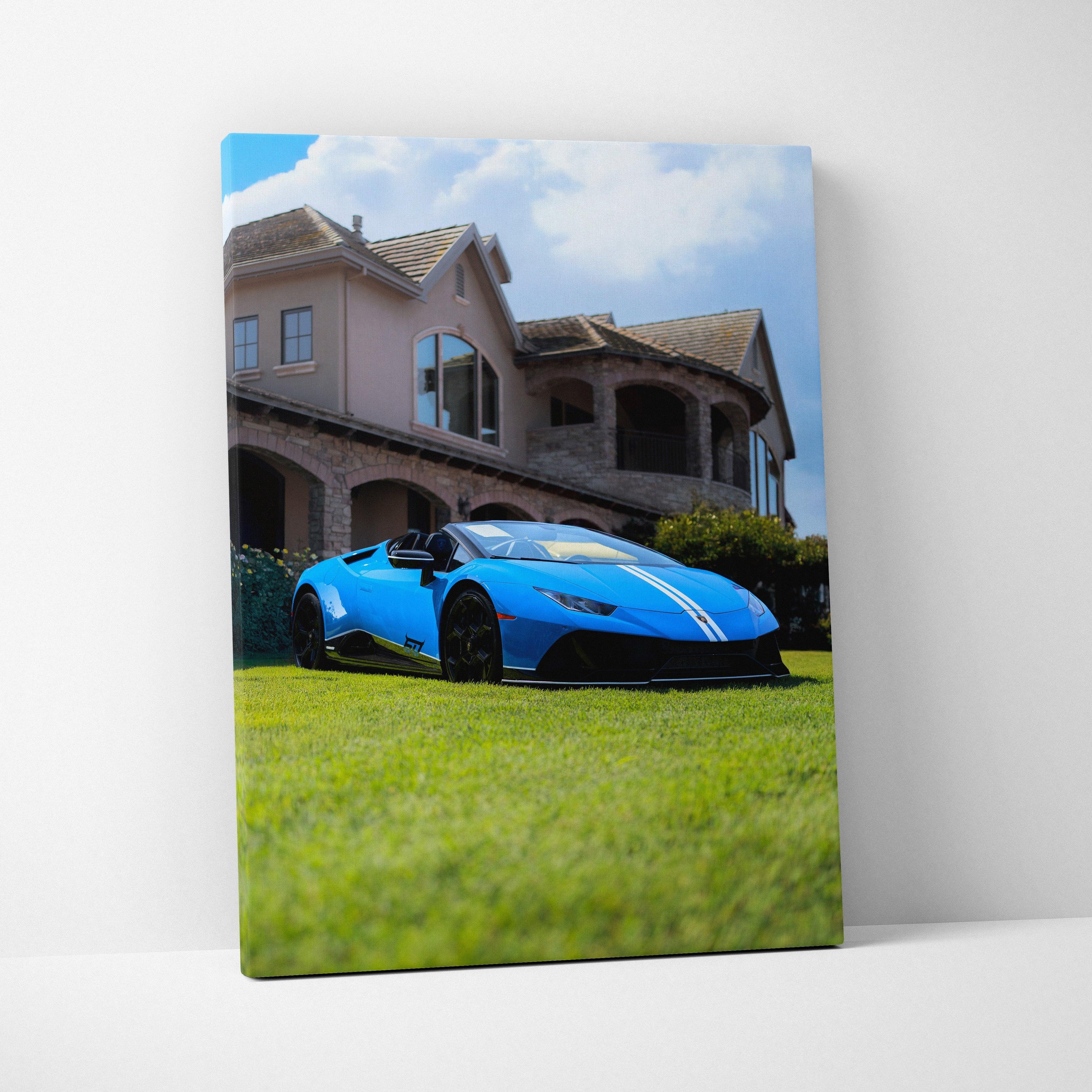Vertical canvas art of a blue Lamborghini Huracan parked on grass with a luxury house backdrop.