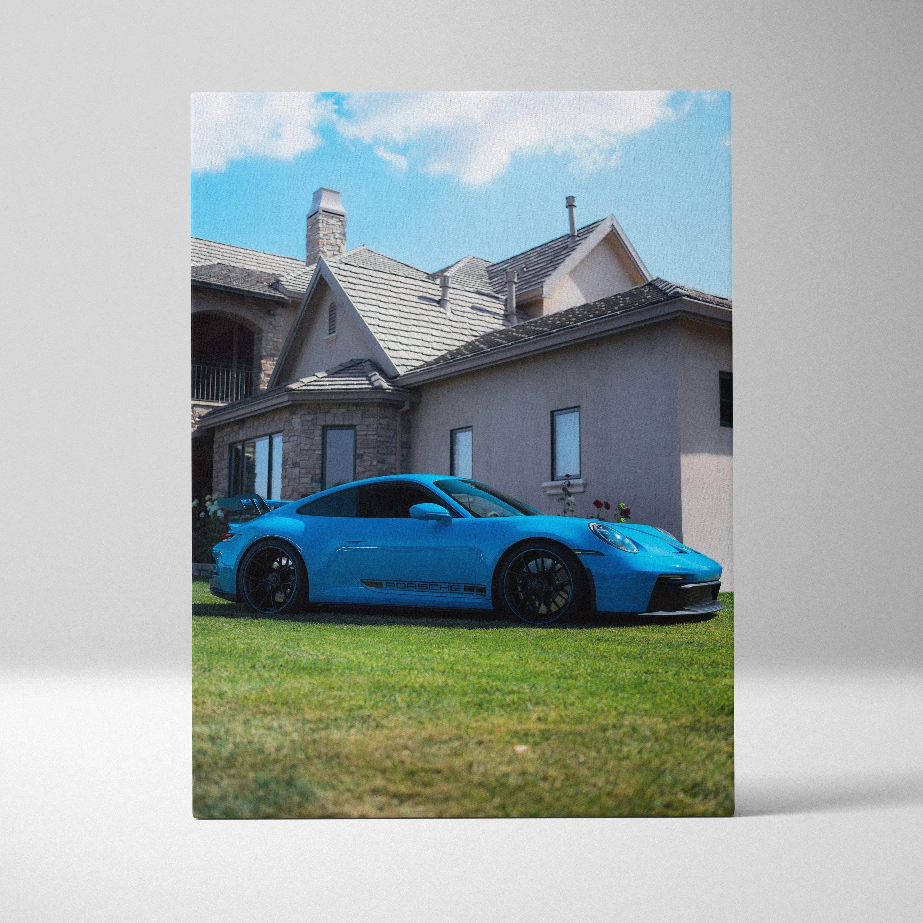 Blue Porsche 911 GT3 parked on grass in front of house canvas art wall decor.