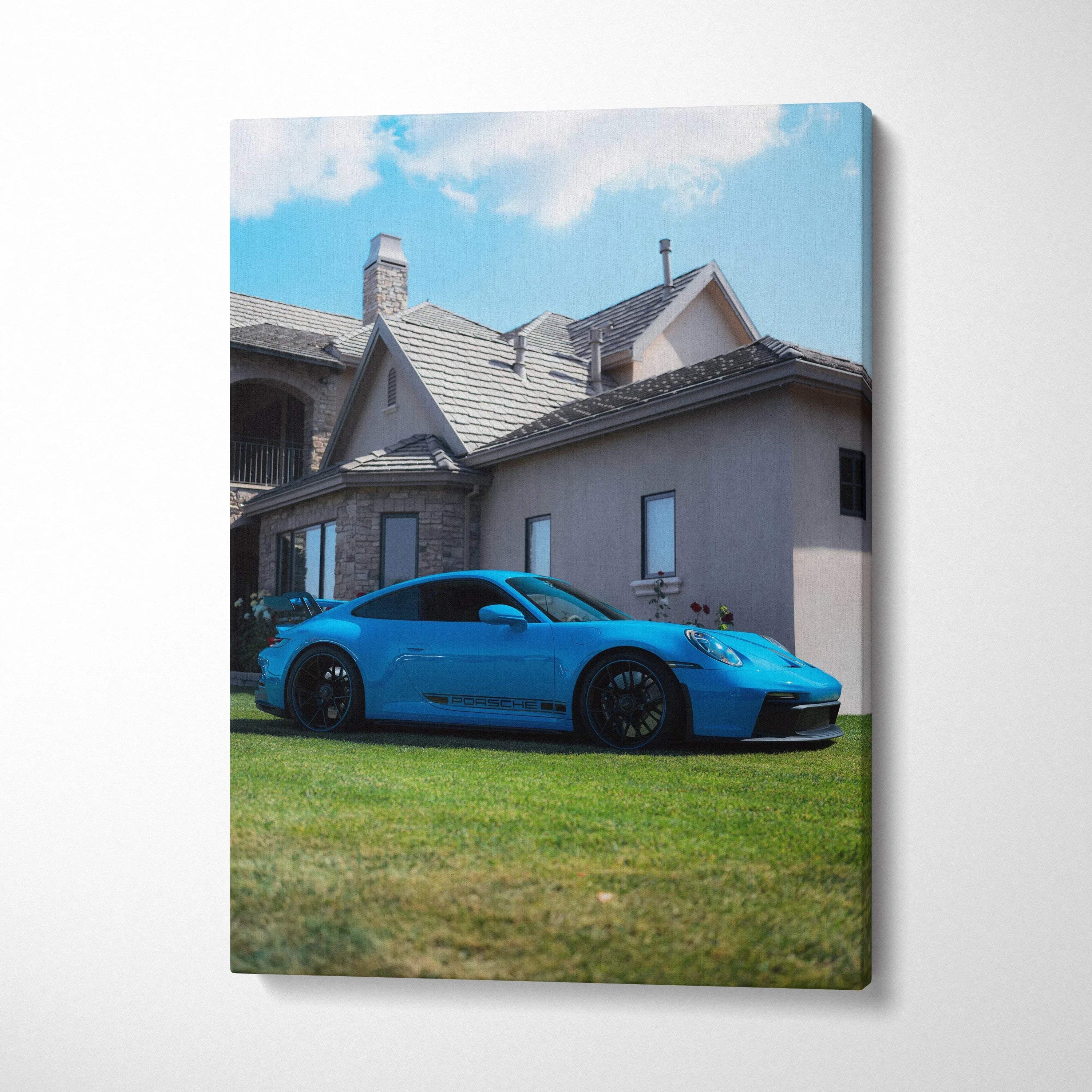 Porsche 911 GT3 in blue parked on grass in front of house canvas wall art vertical print.