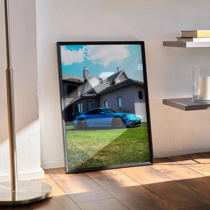 Porsche 911 GT3 blue car poster leaning against wall with house background wall art.