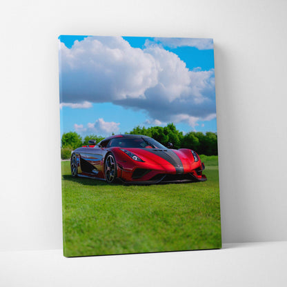 Koenigsegg Regera red sports car on green grass under blue sky canvas wall art print.